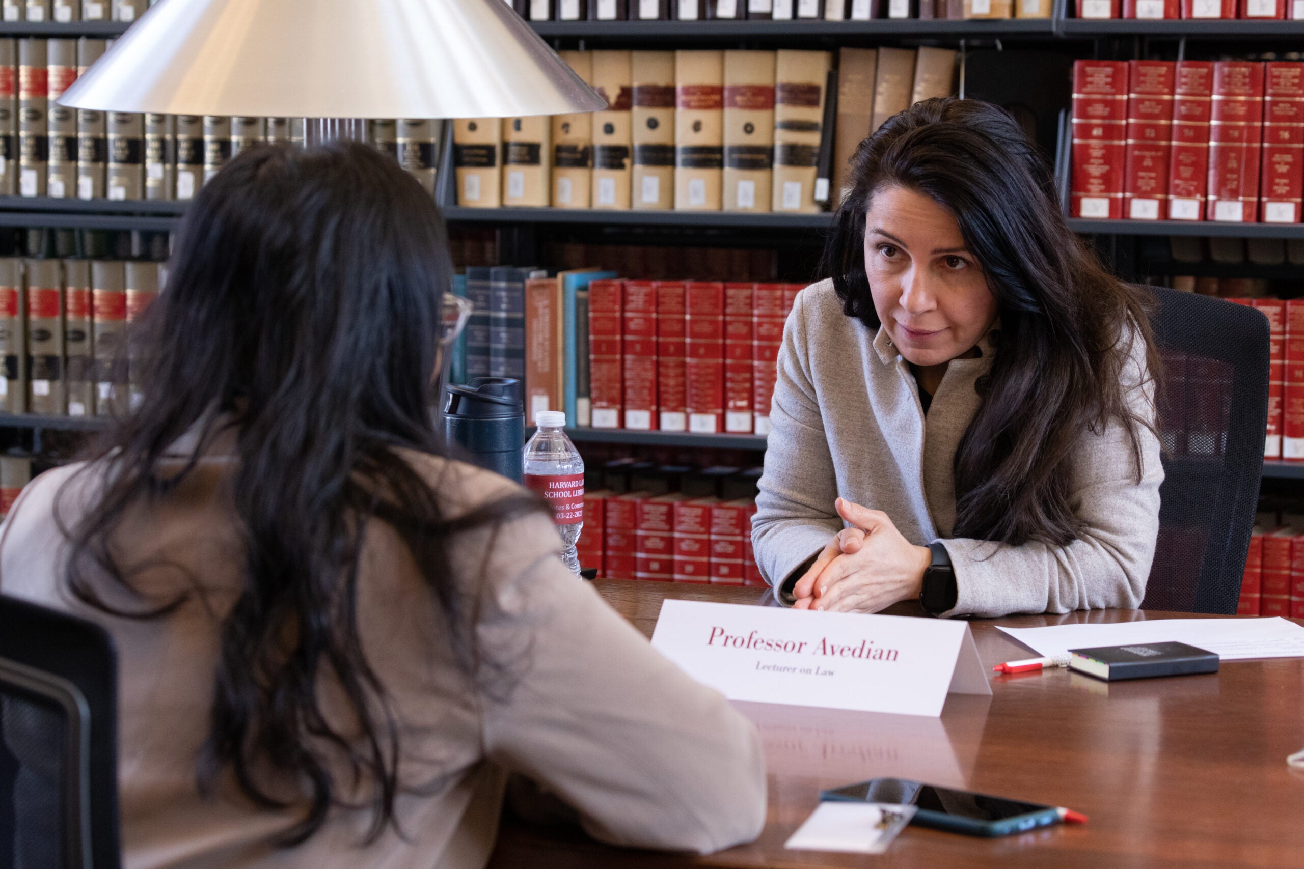 Two people at a table taking