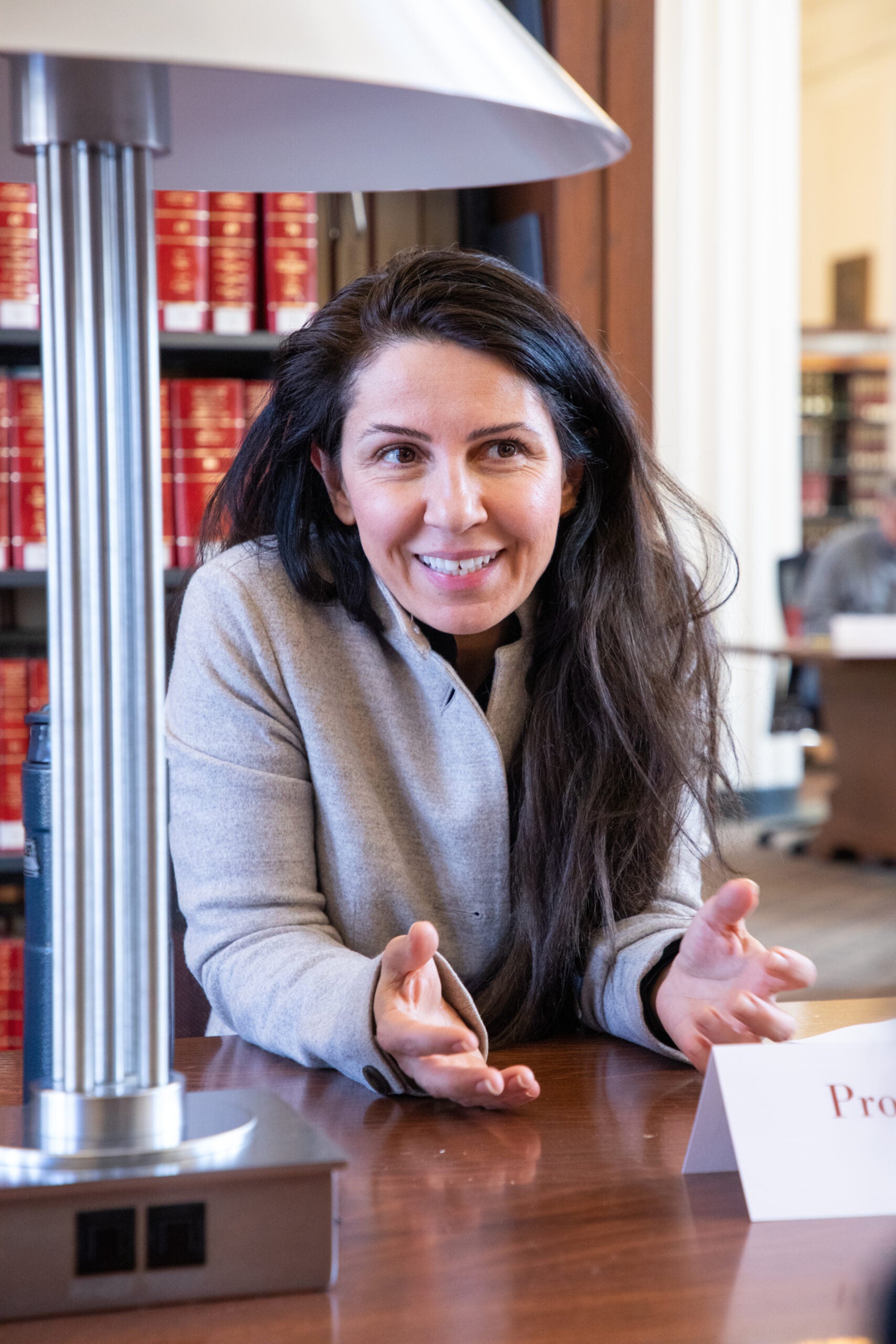 A close up of a woman talking with someone at a table