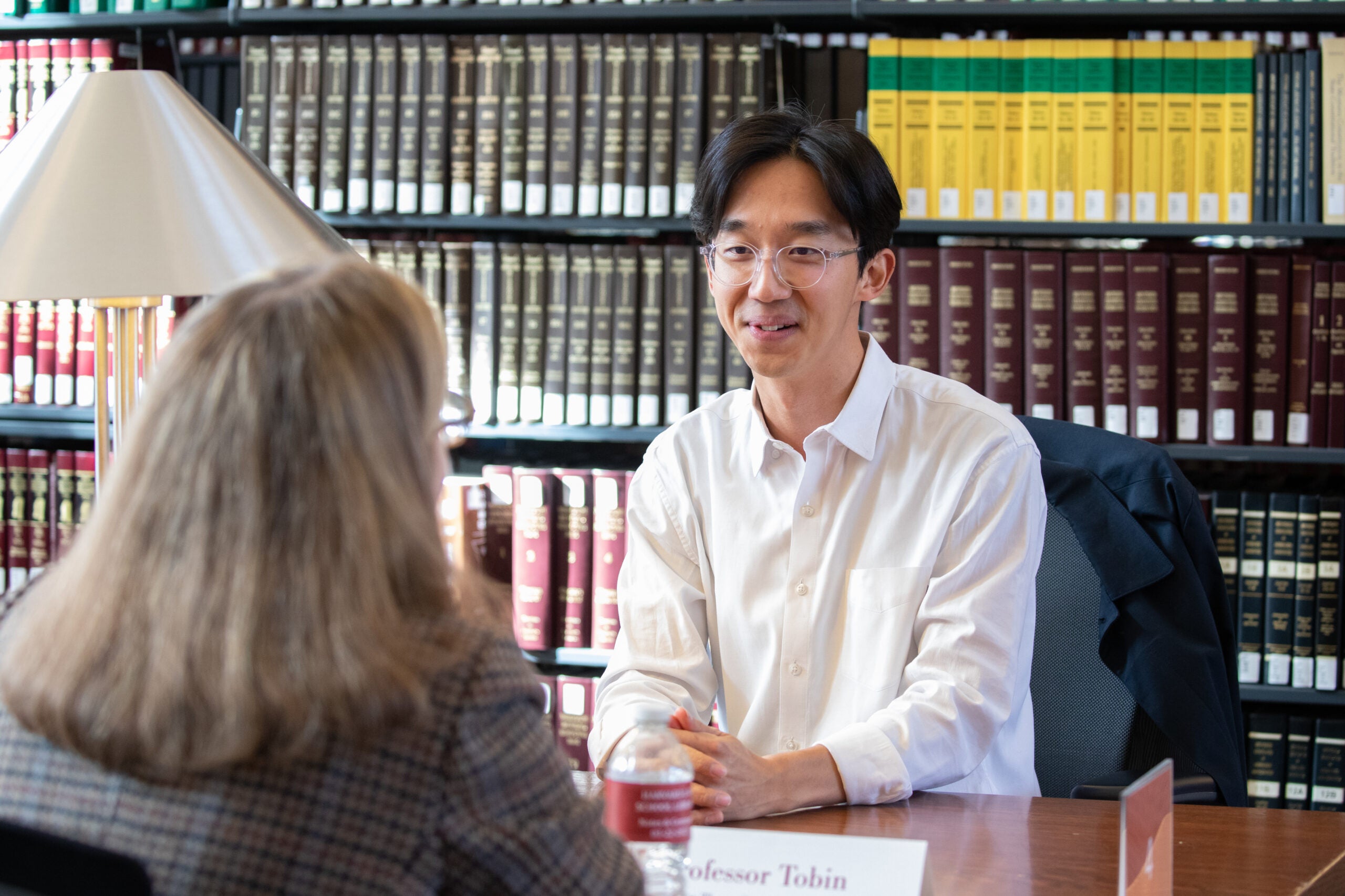 Two people conversing in the library