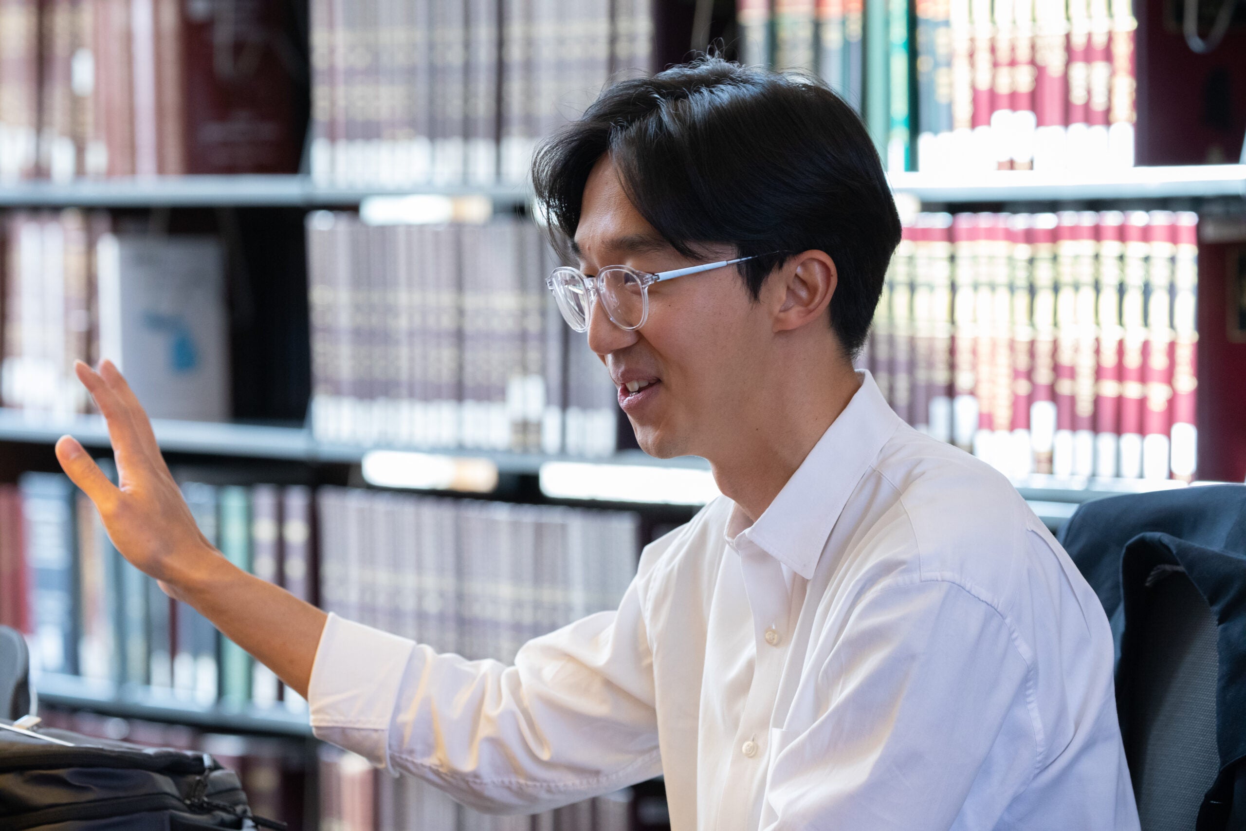 A close up of a man speaking in a library