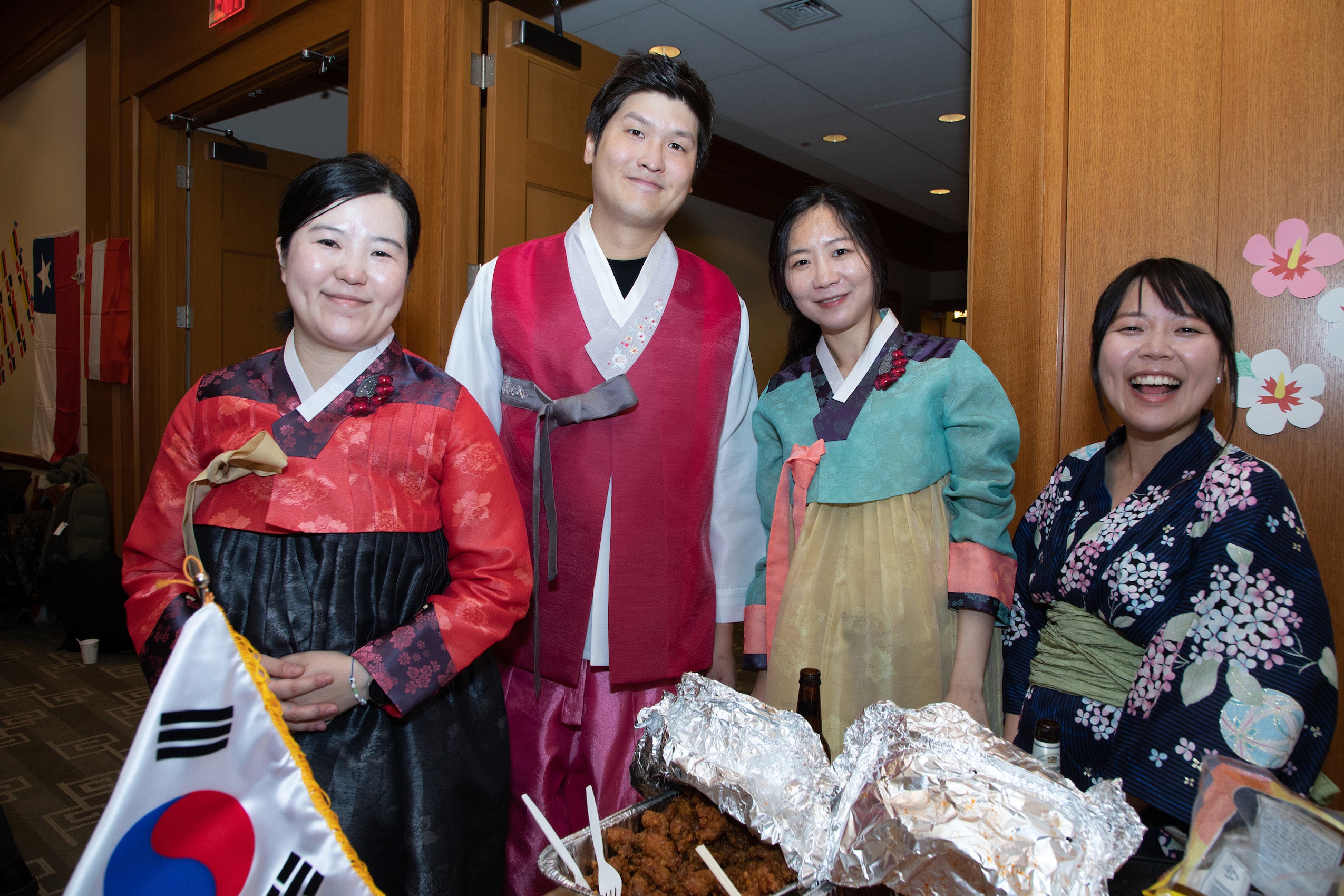 Four people wearing dress clothing from their countries