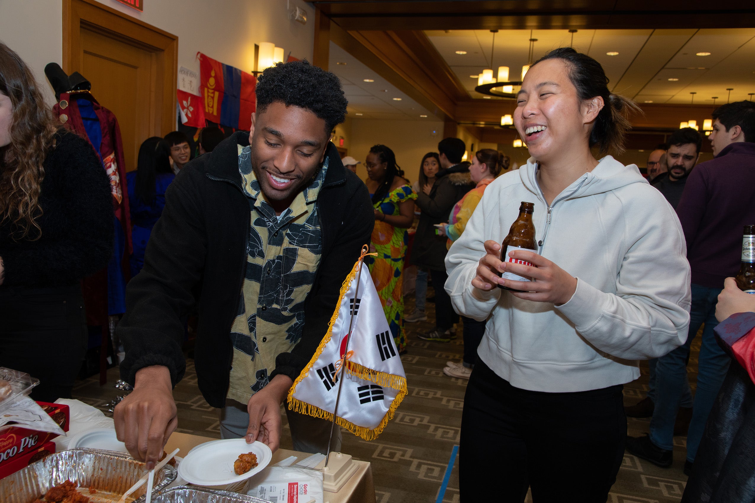 Two people near a table of food at a party