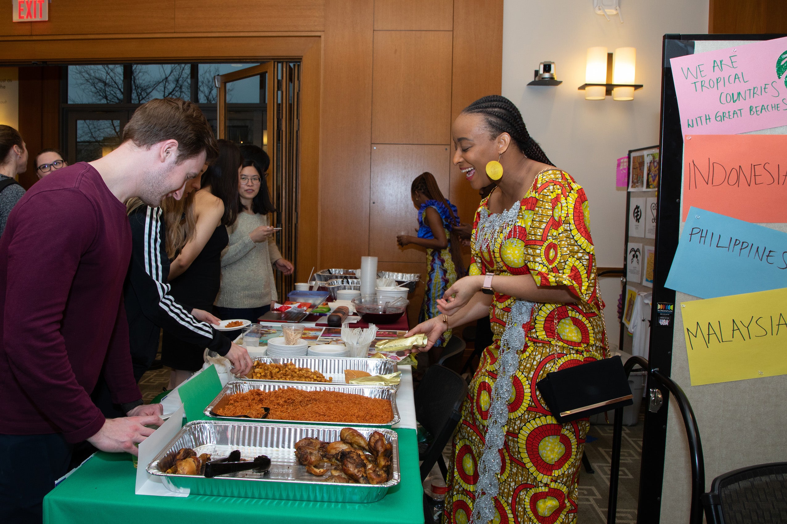 People getting food at a buffet table at an event