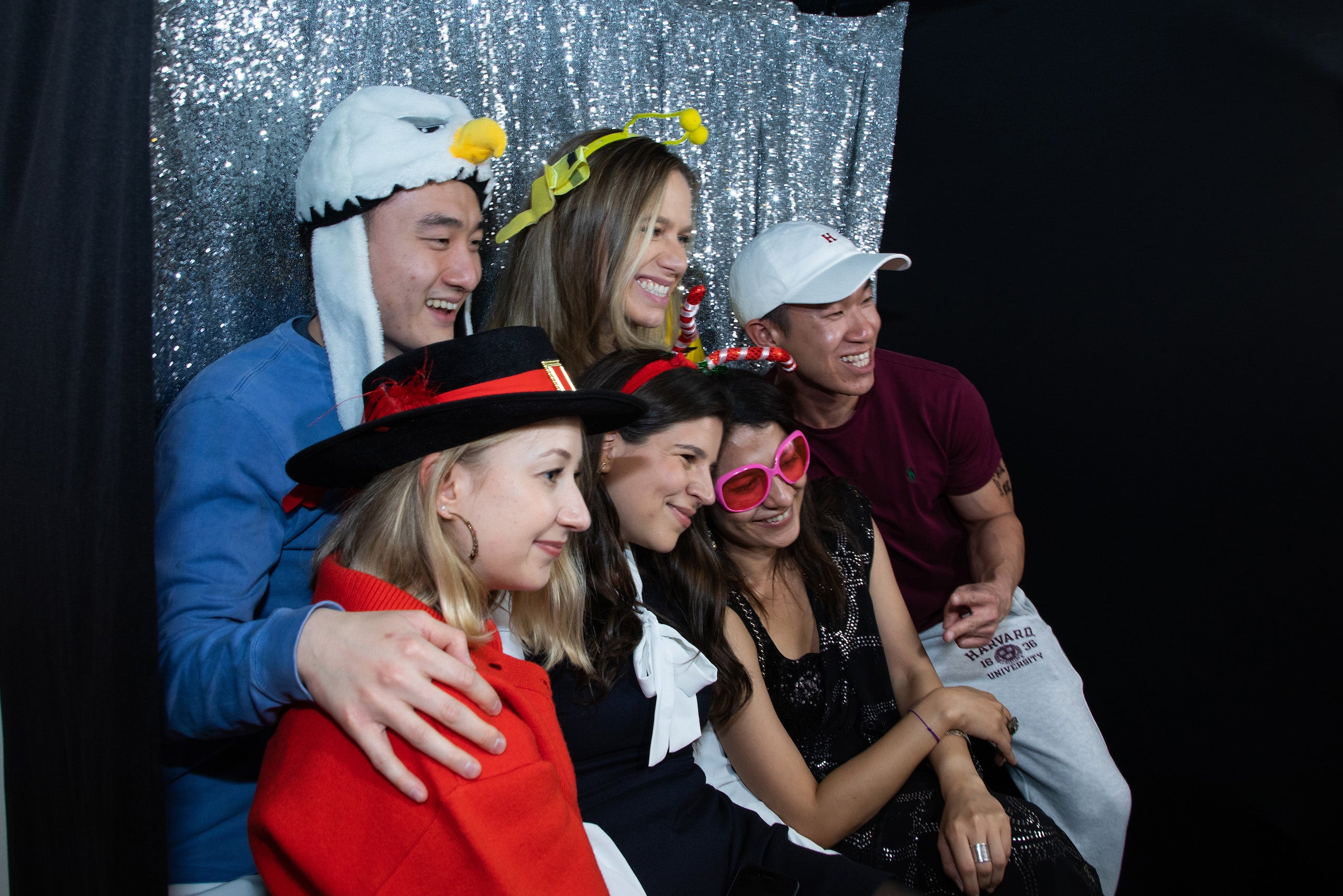 Six people pose for a photo at a photo booth