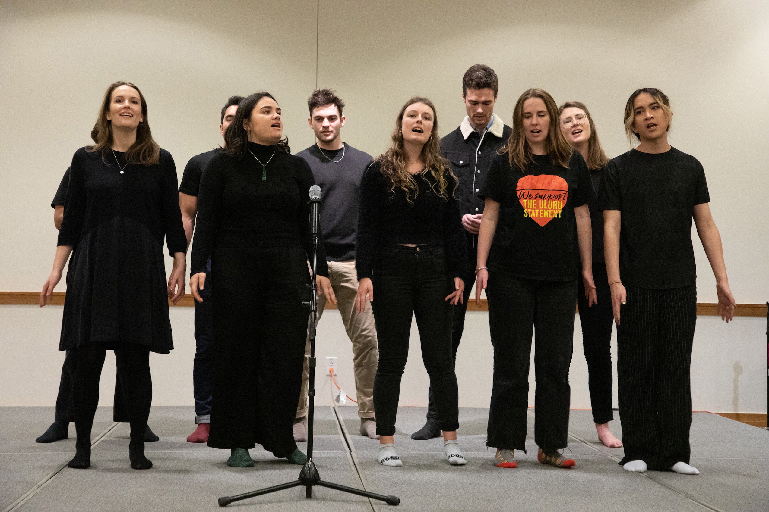 A group sings on a stage