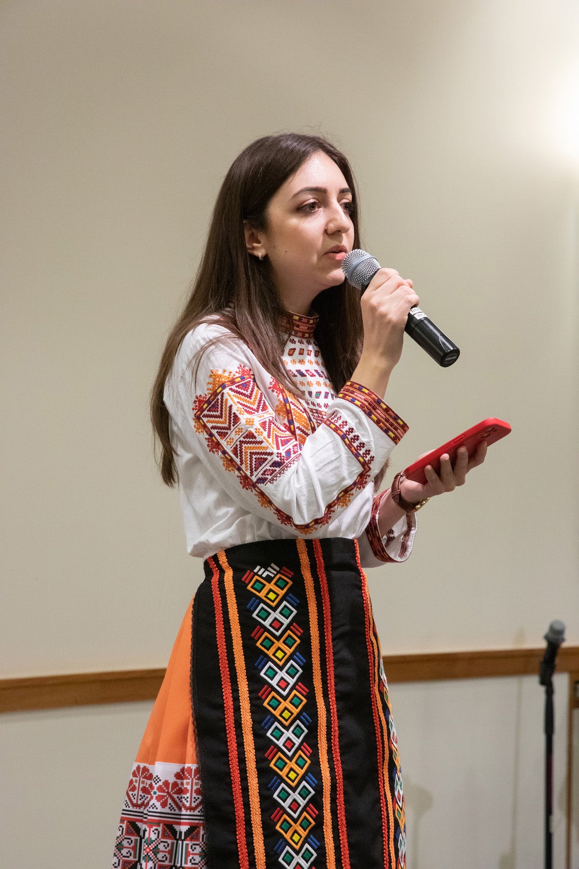 A woman sings into a microphone