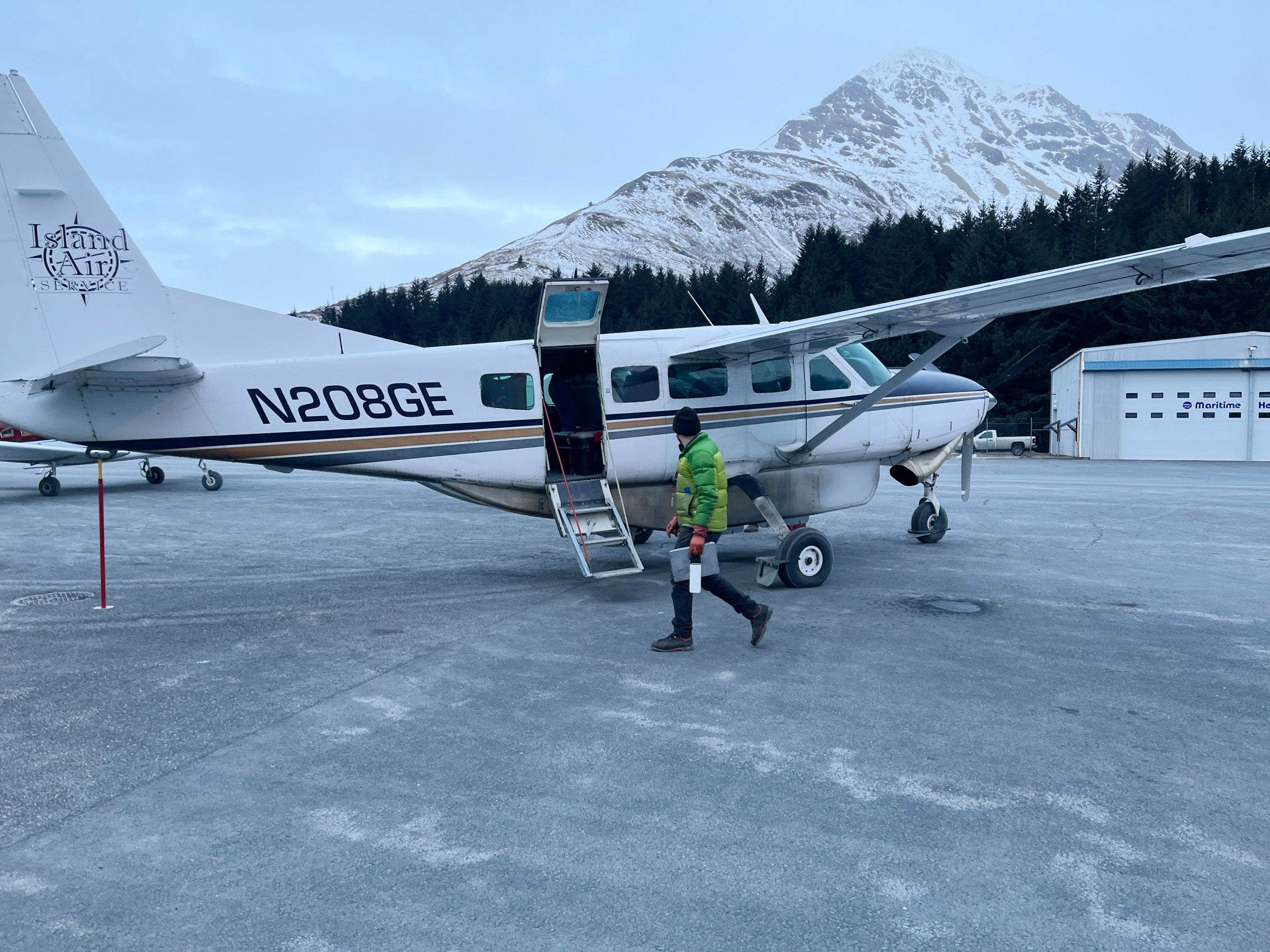 A man walking near a small plane