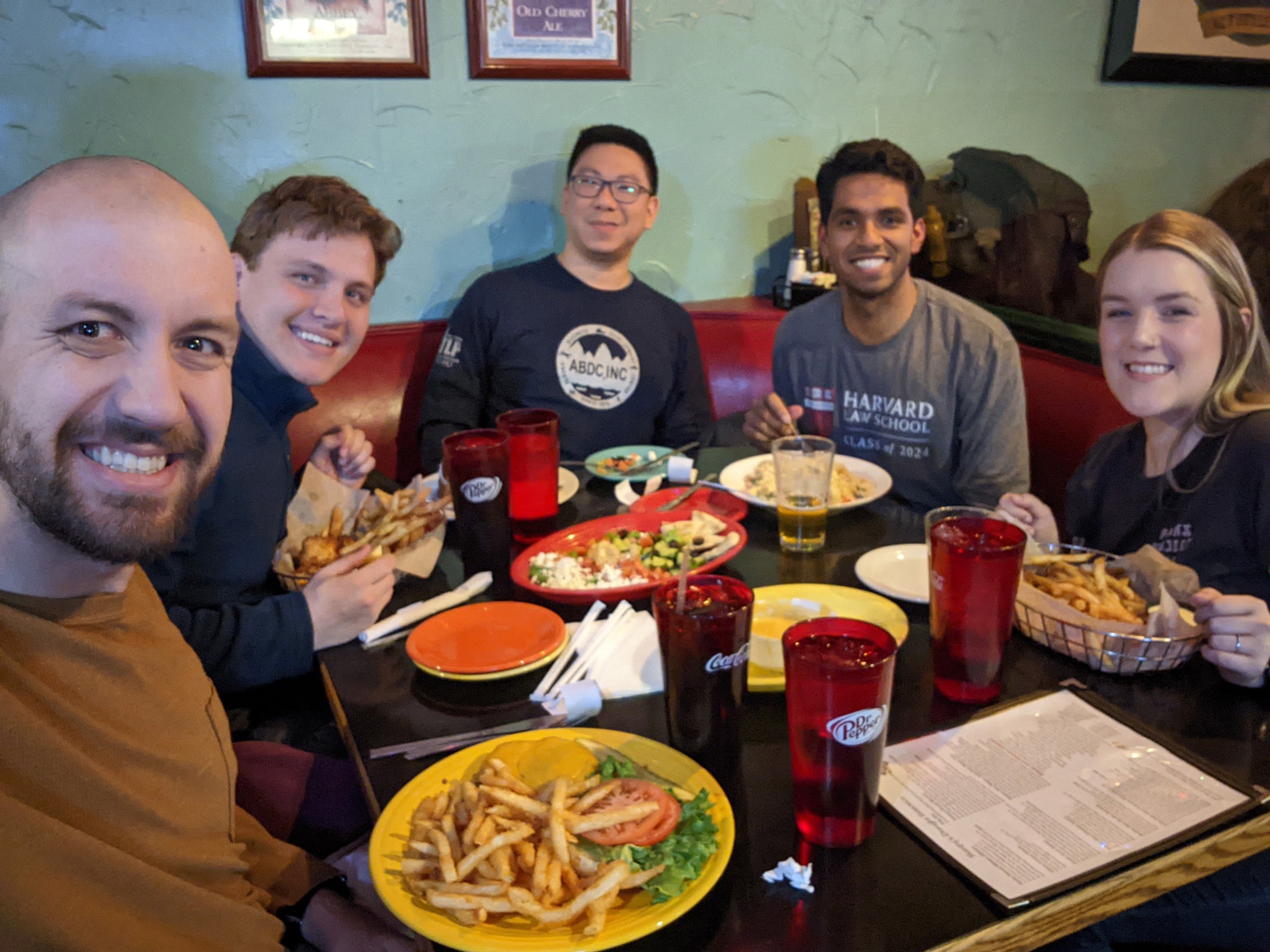 A group of people sitting around a table having meal
