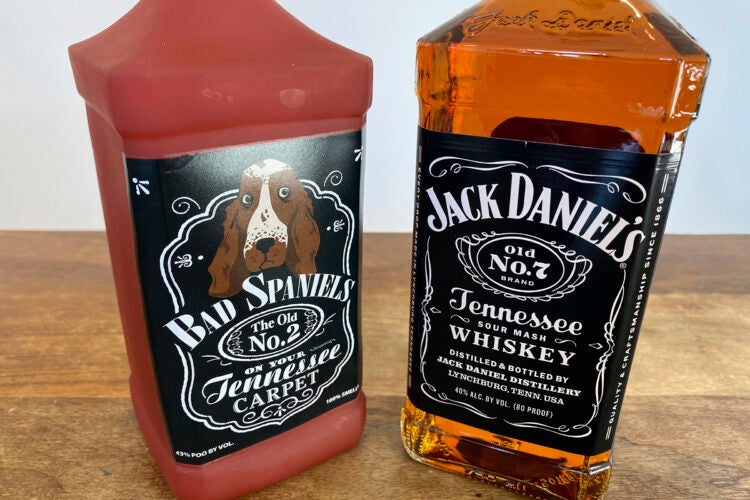 A bottle of Jack Daniel's Tennessee Whiskey is displayed next to a Bad Spaniels dog toy.