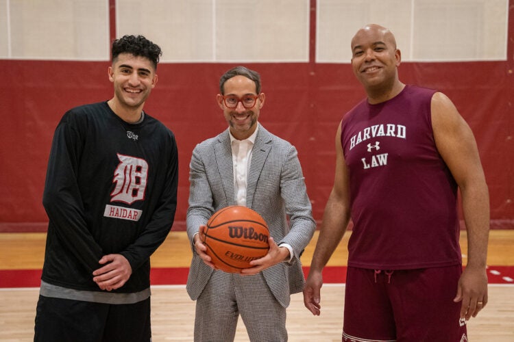 three people at the start of a basketball game