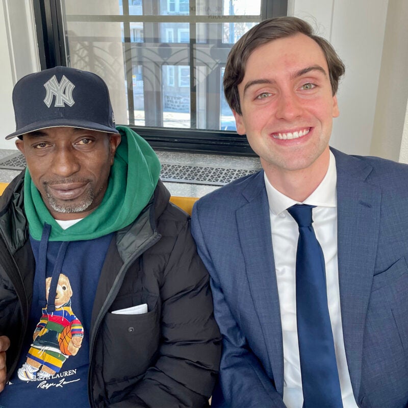 Paul Buchanan and Martin Rather sitting together on a bench.