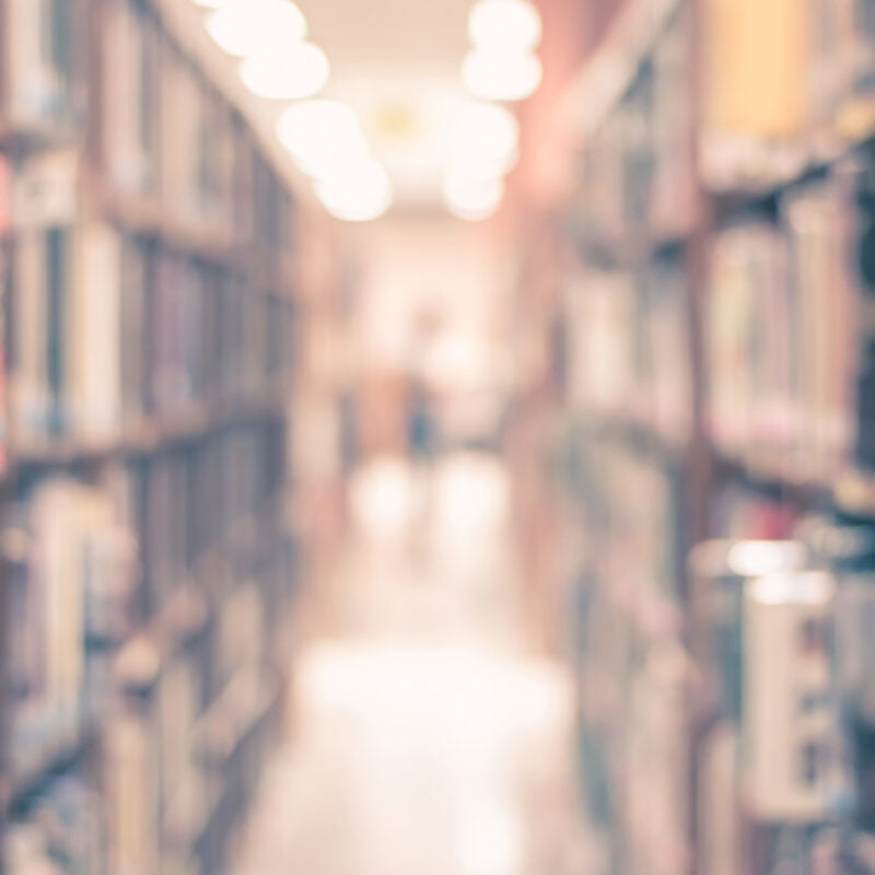 Blurry shot of bookshelves.