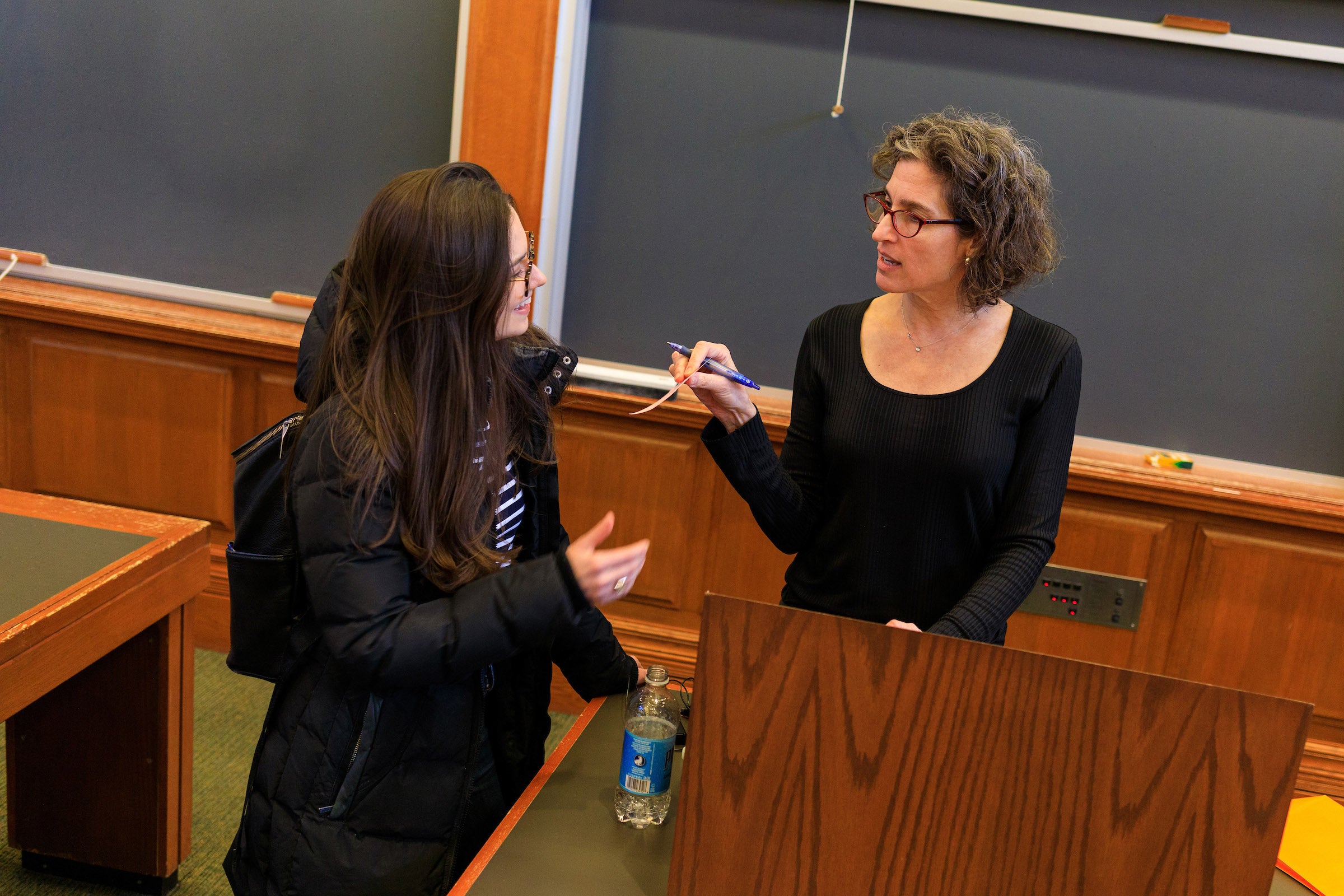 Alexandra Natapoff hands a student a