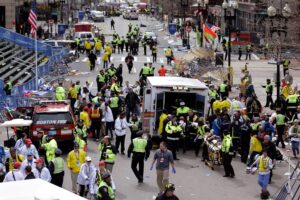 Medical workers aid injured people following two explosions at the finish line of the Boston Marathon on April 15, 2013.