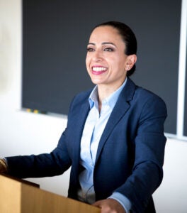 woman at a podium in front of a classroom