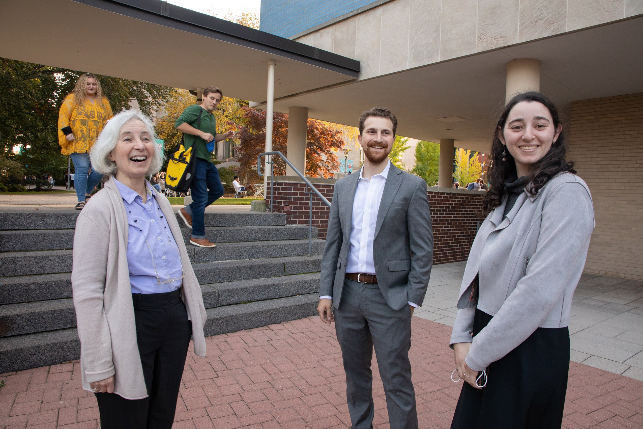 Martha Minow stands outside with students