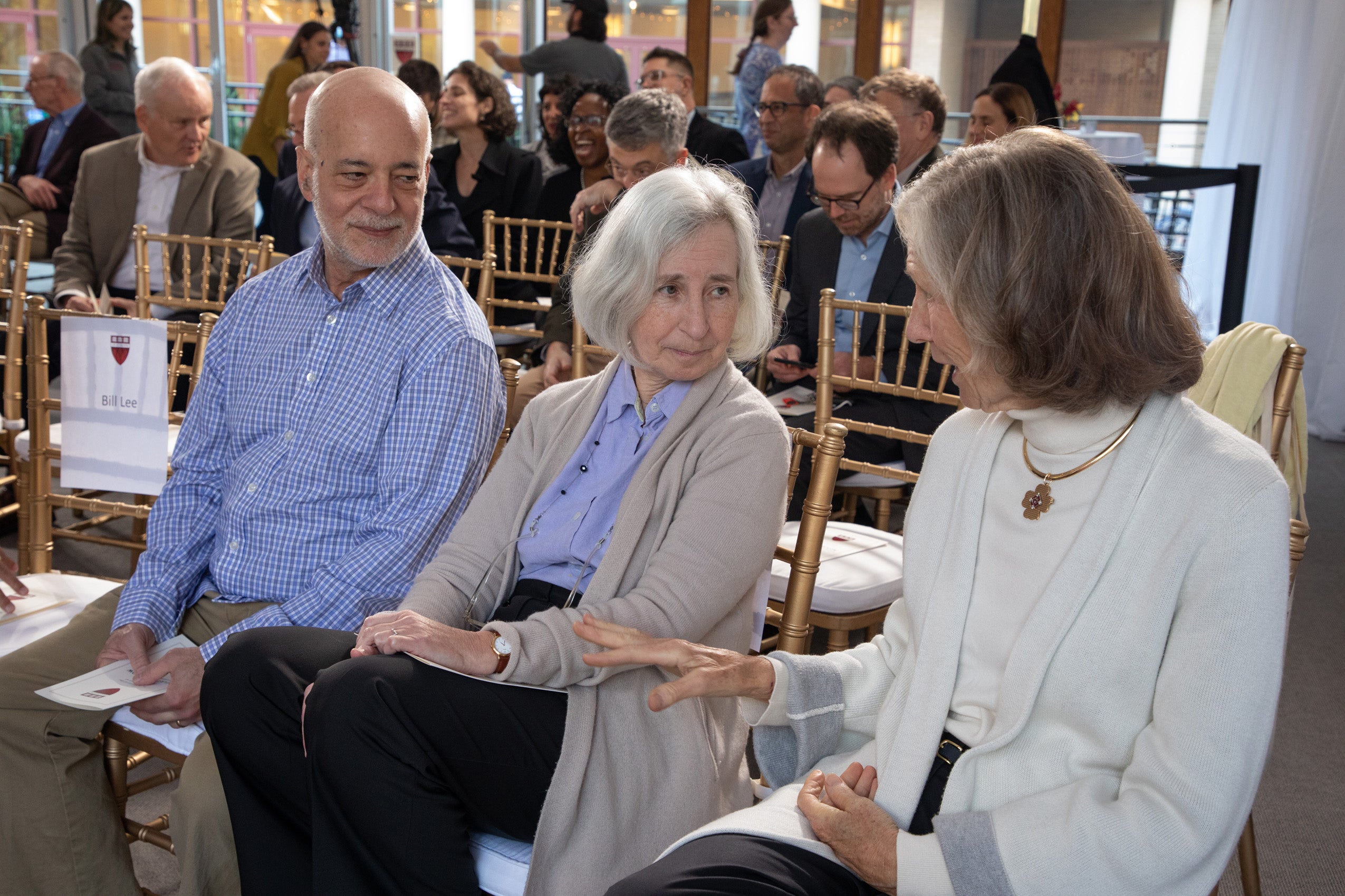 Woman speaking to two people