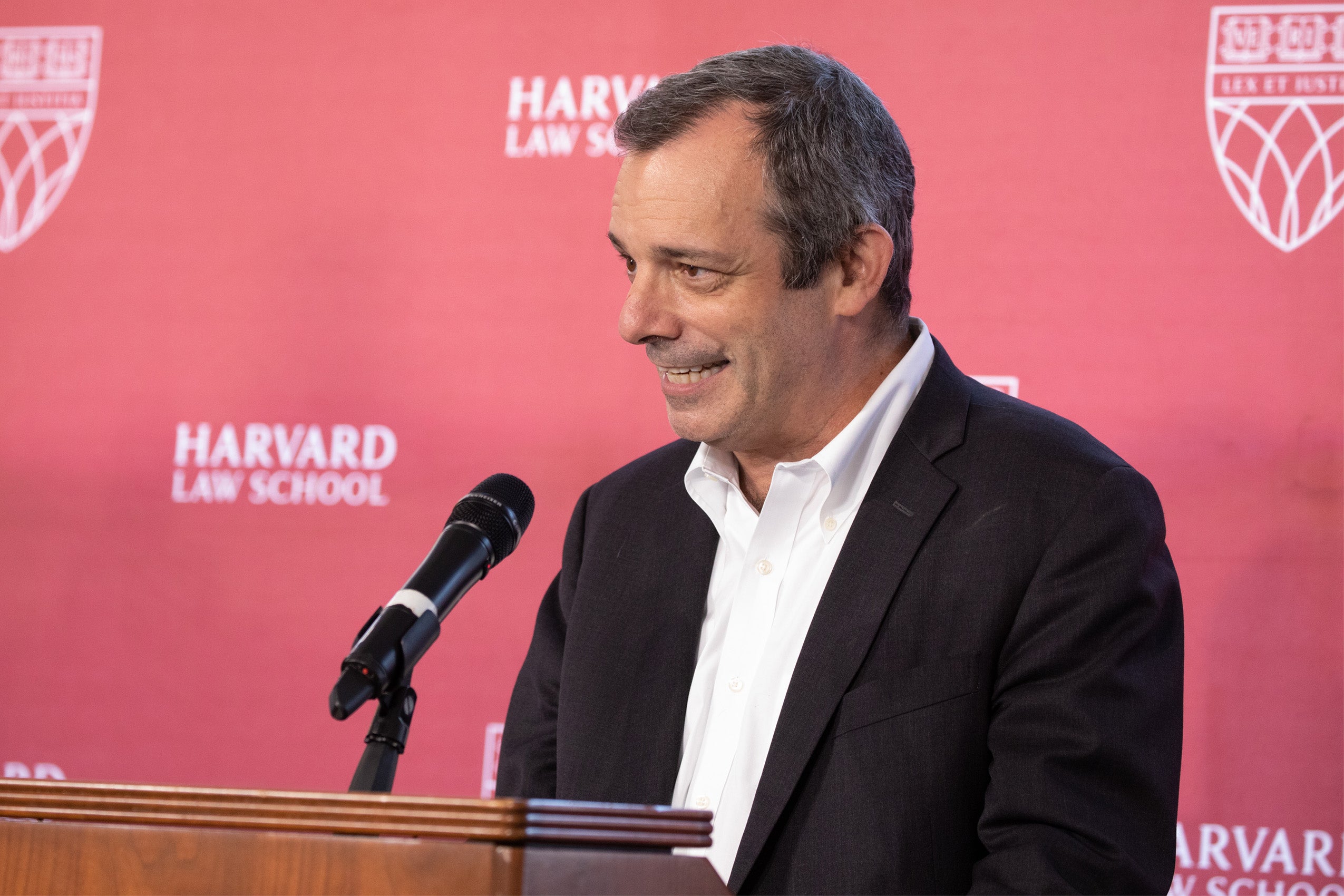 Dean John F. Manning speaking at a podium
