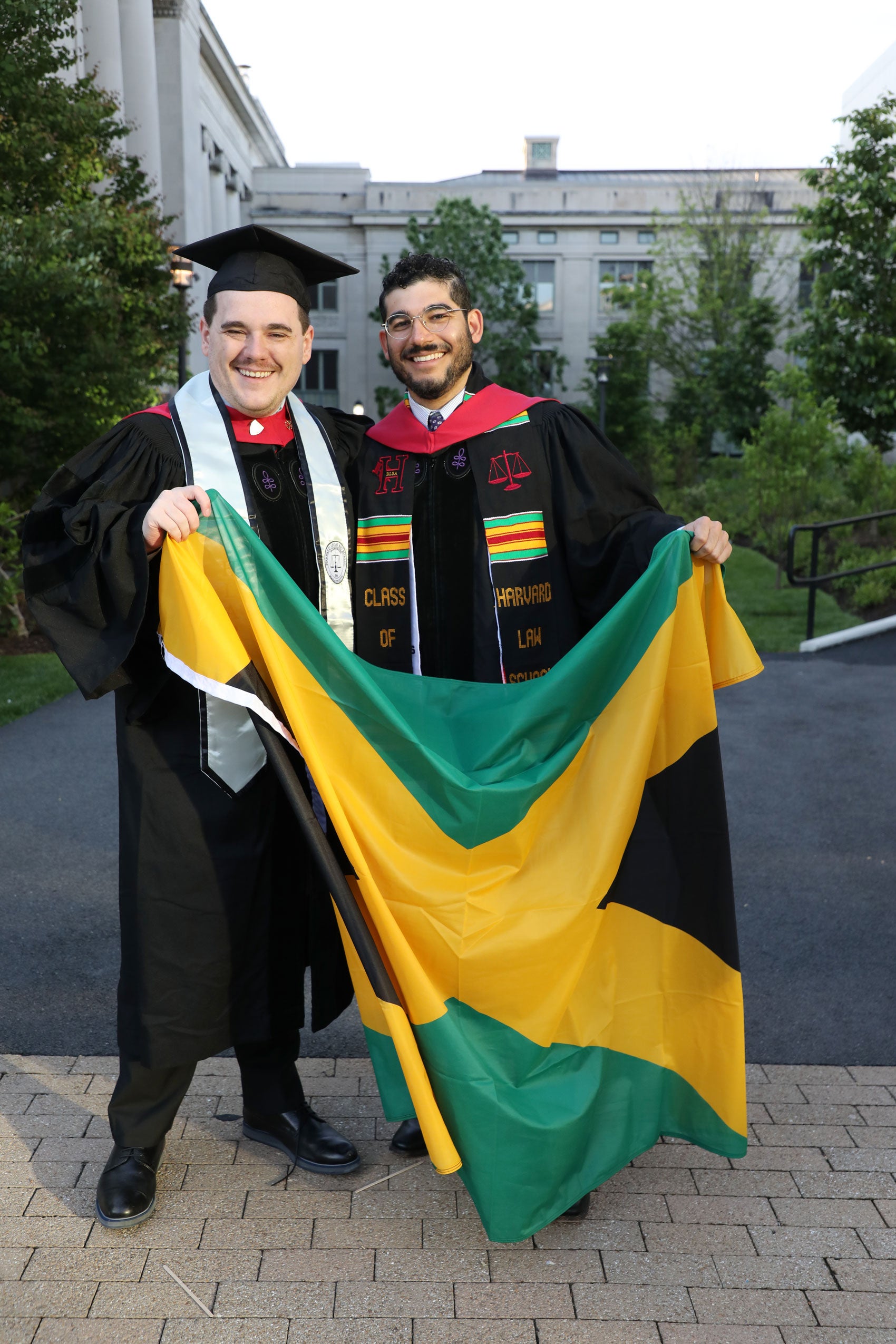 Two graduates holding Jamaican flag
