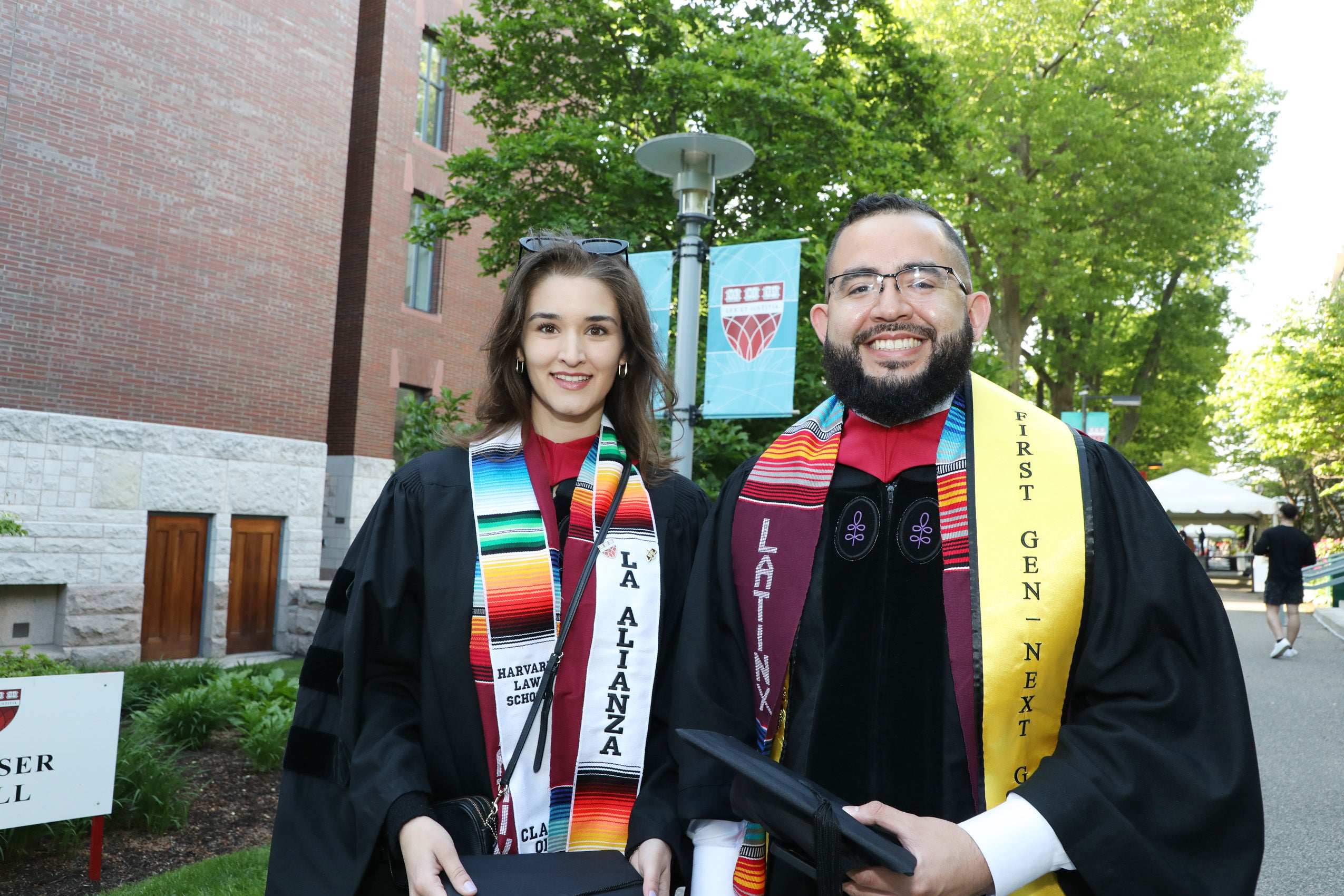 Graduates wearing La Alianza and LatinX sashes pose on Commencement Day