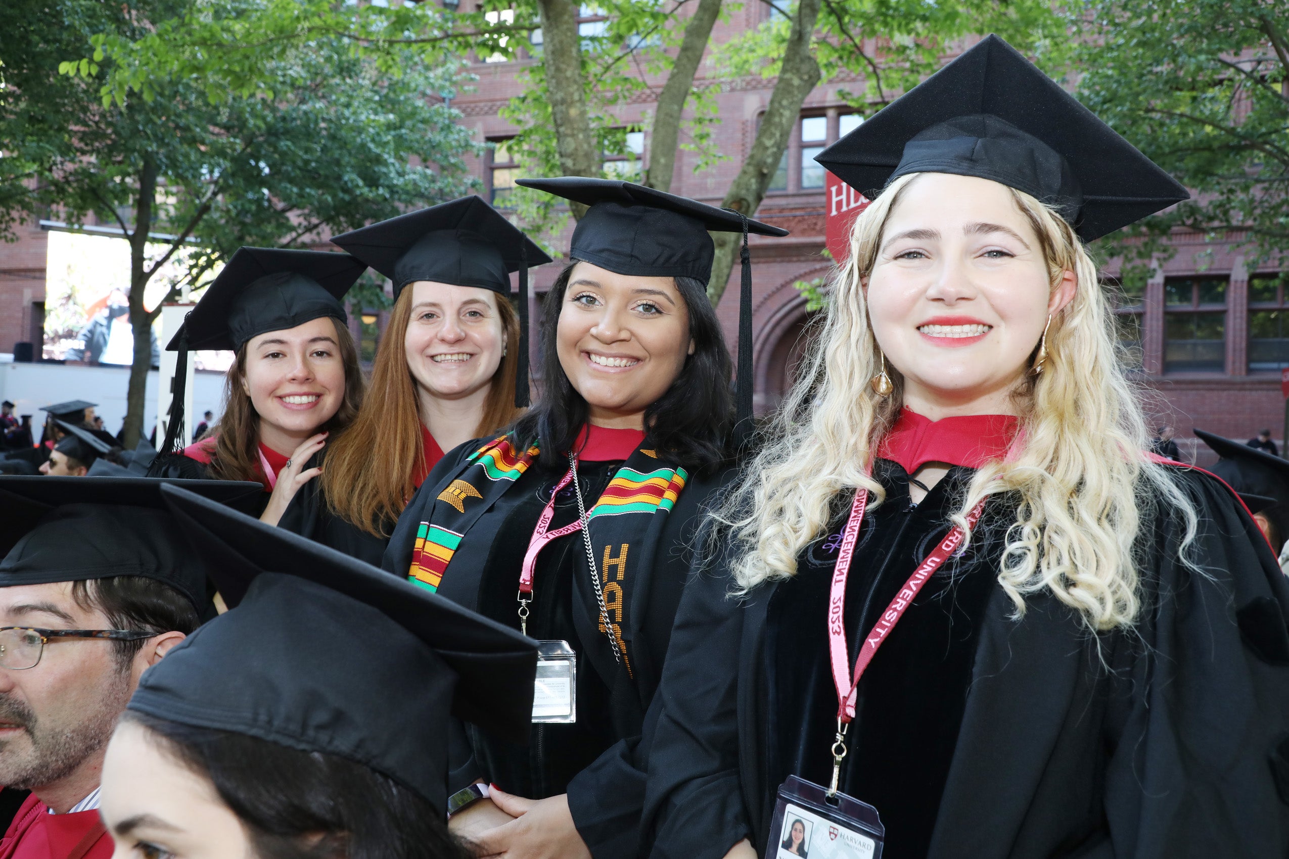 Four women in regalia pose together