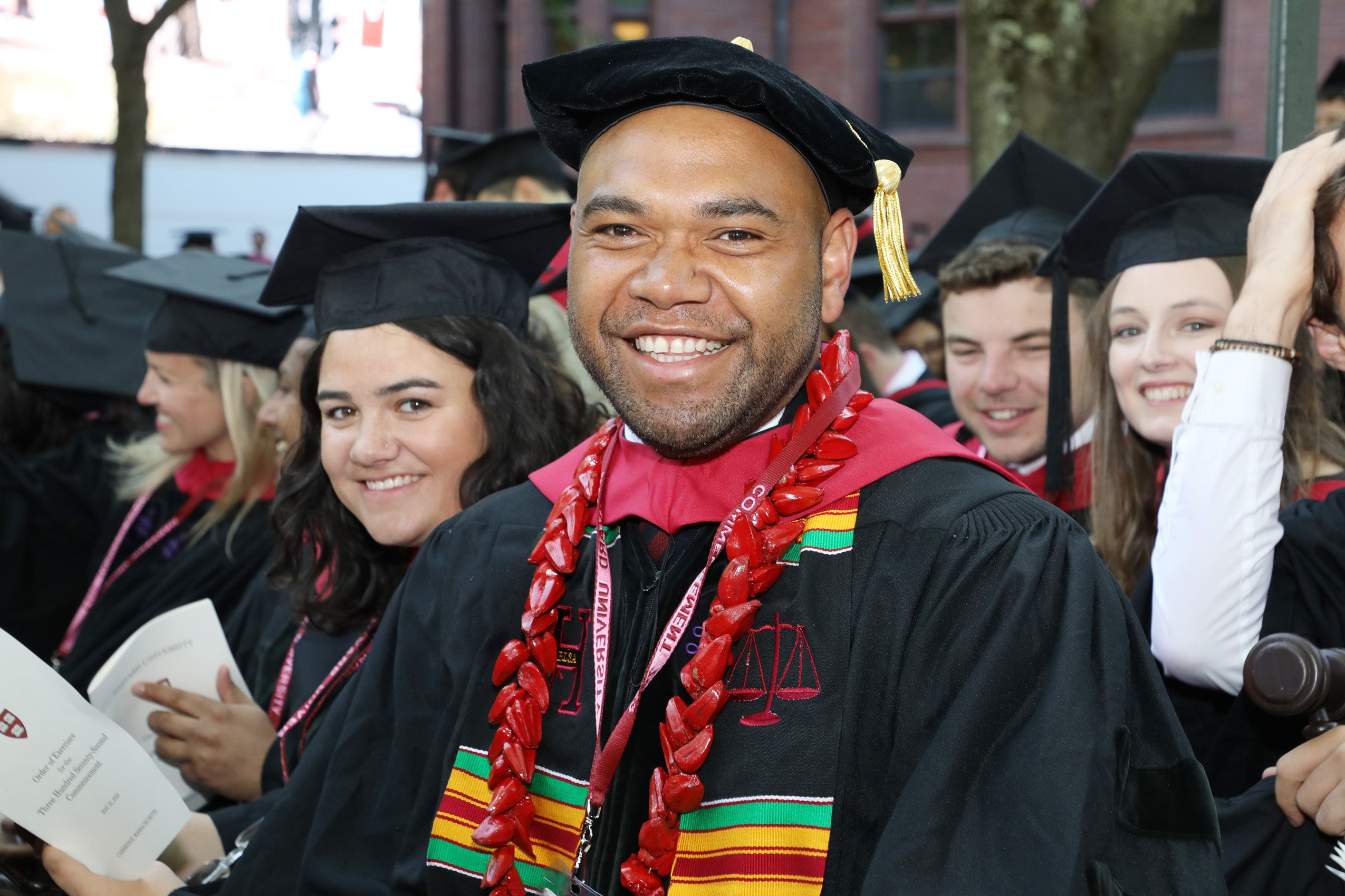 Man in regalia smiles