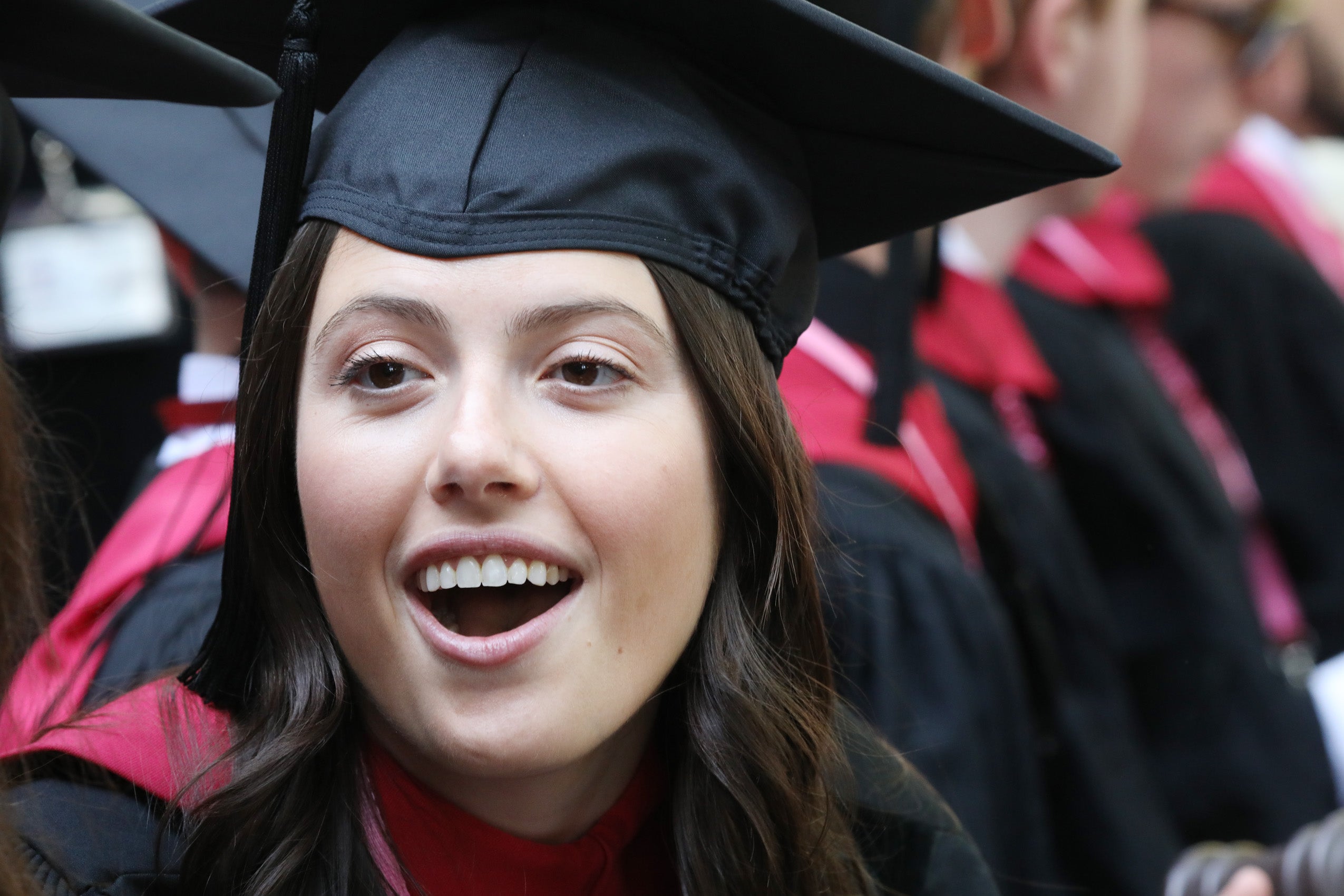 Woman wearing regalia give surprised look