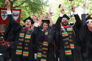 Grads with BLSA sashes cheer and hold up gavels