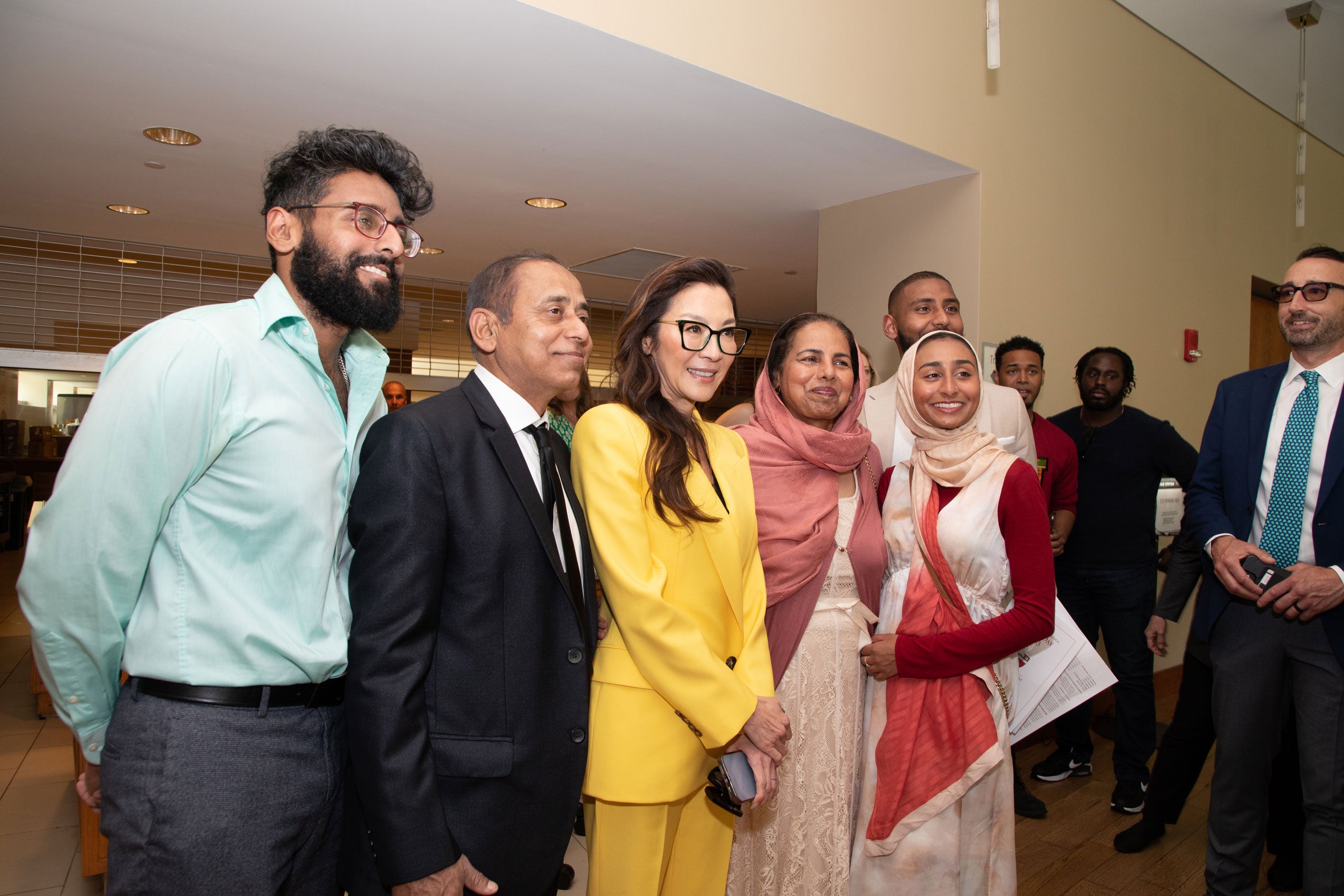 Michelle Yeoh posing with a group of people