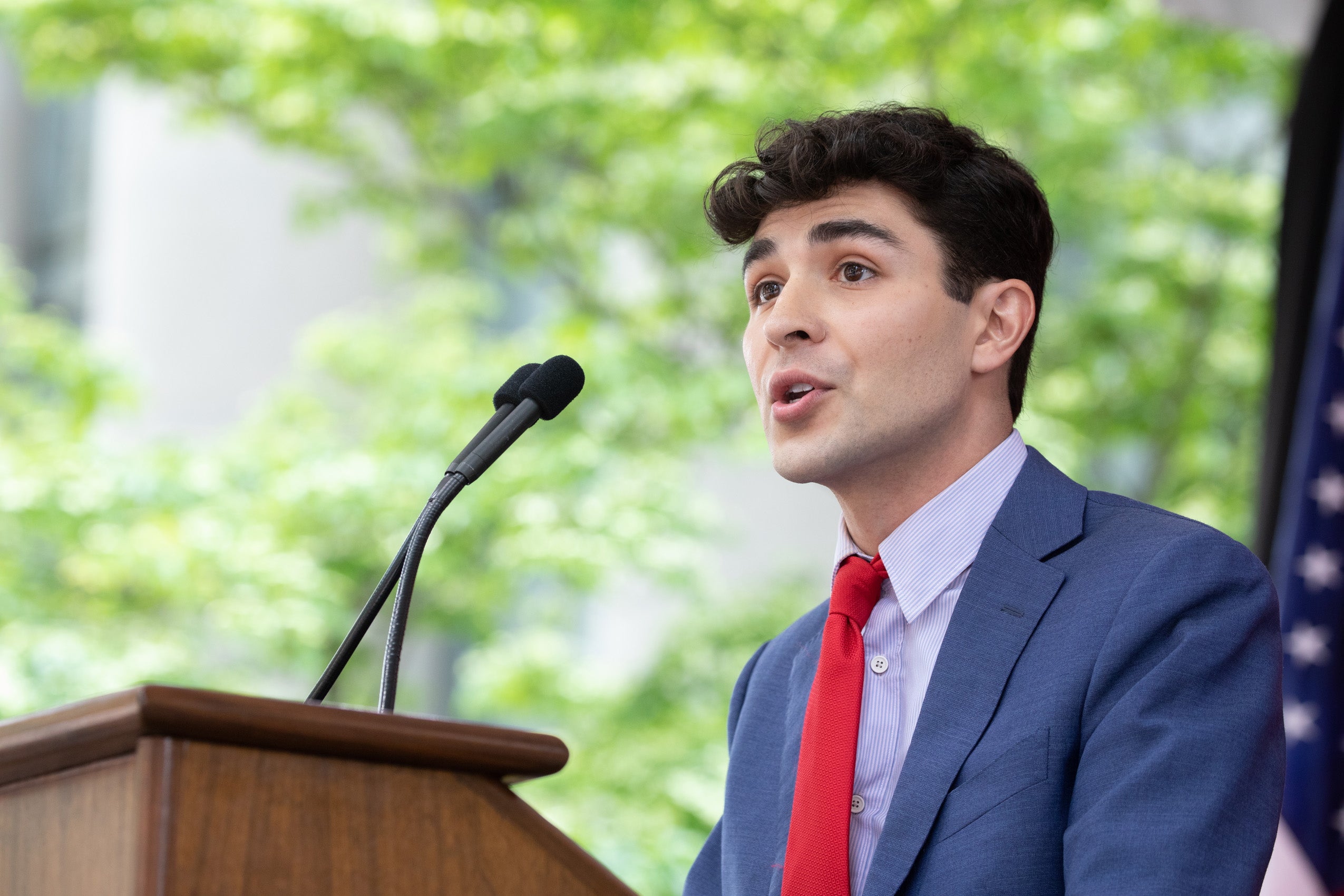 Mean speaks at podium