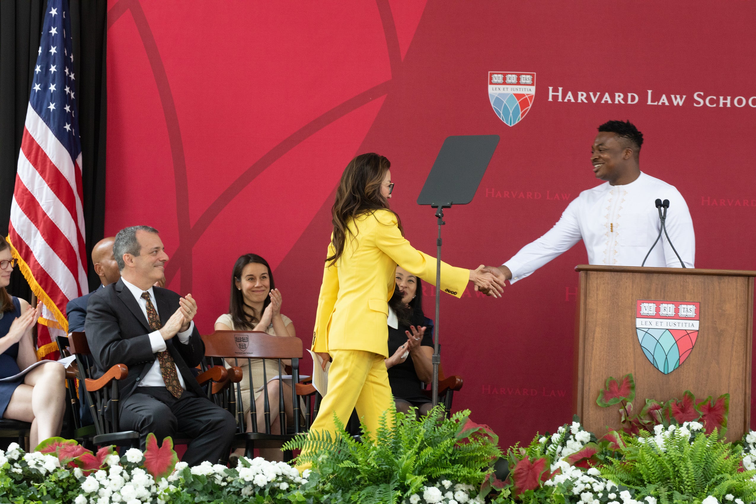 Michelle Yeoh shakes Ayodele Aruleba's hand as she's about to deliver her keynote speech