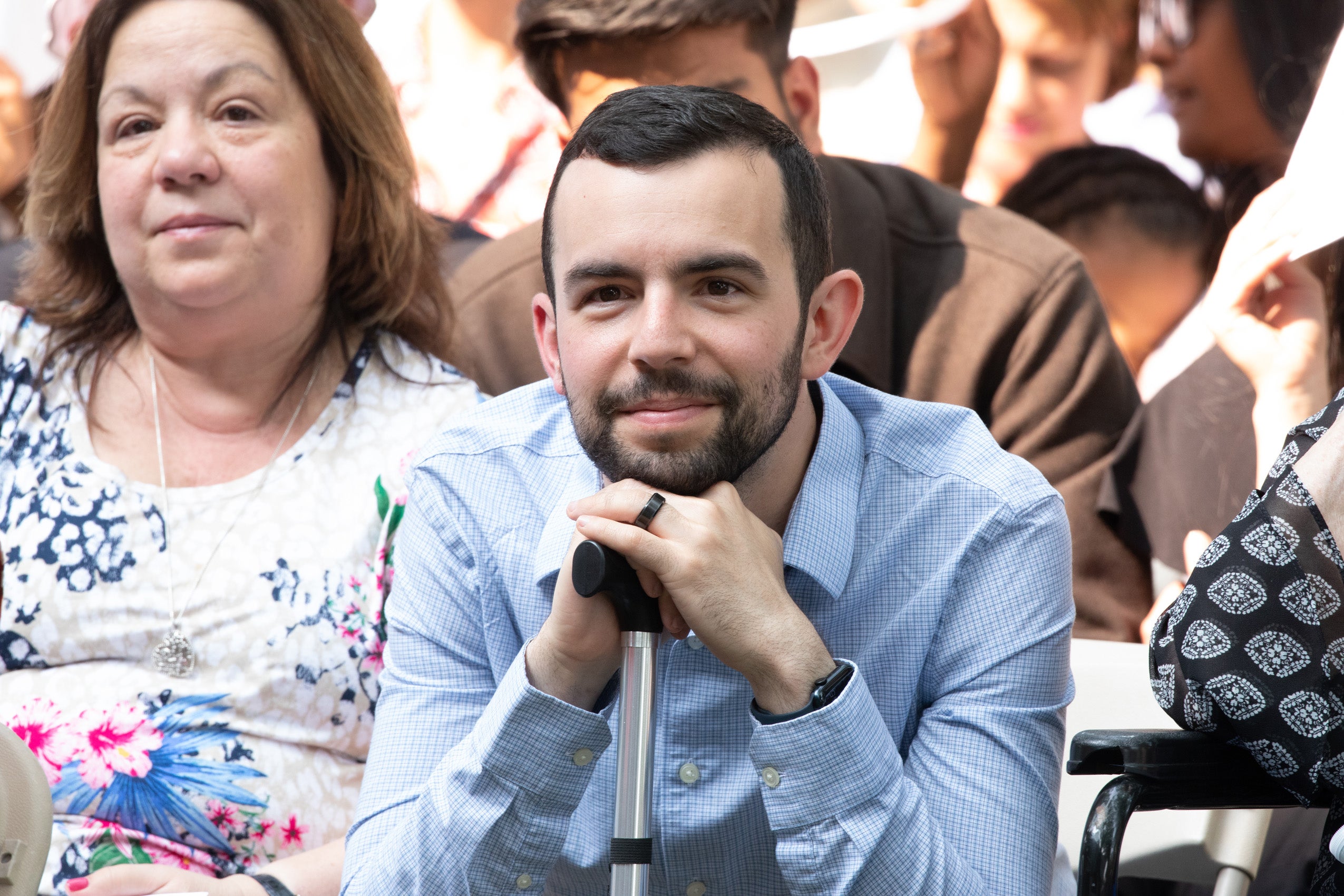 person resting chin on hands listening intently