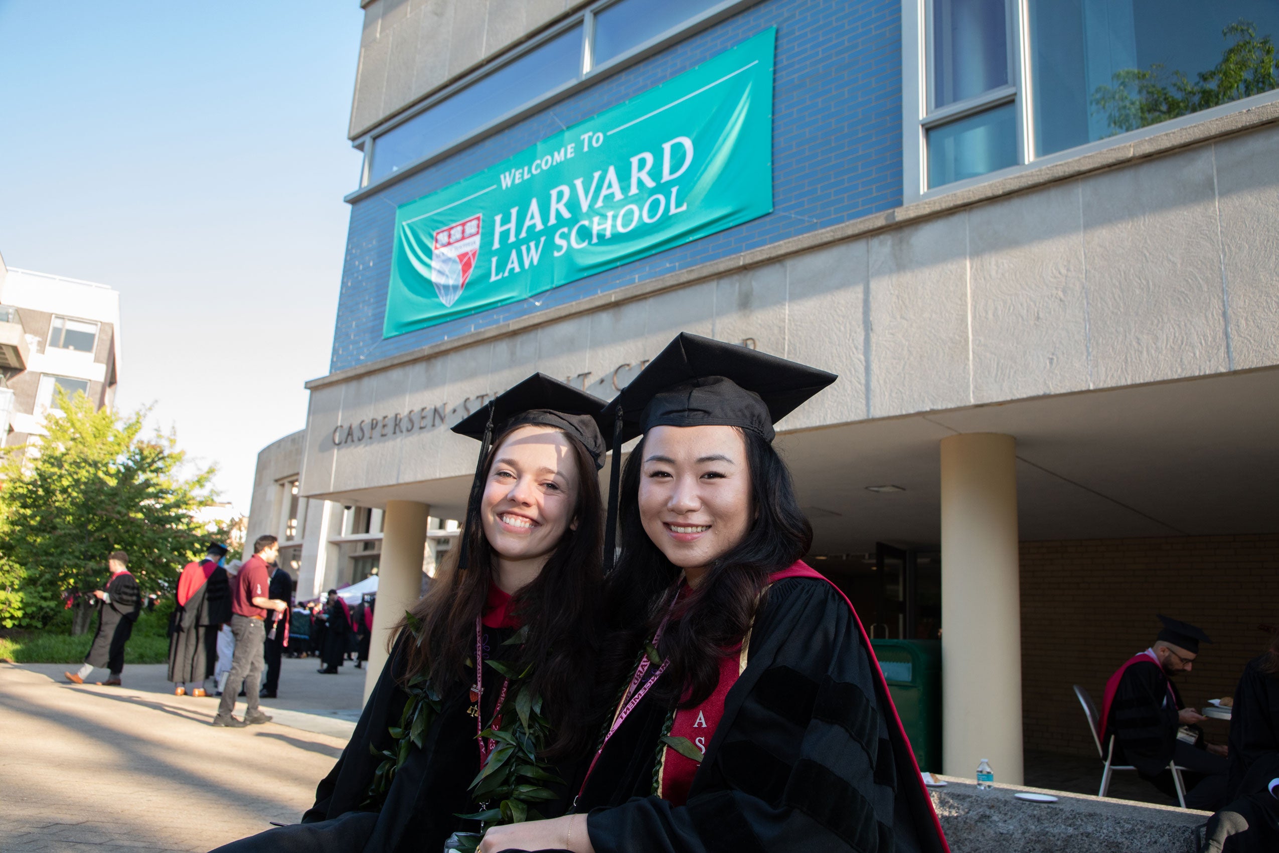 Two female grads pose together outside WCC