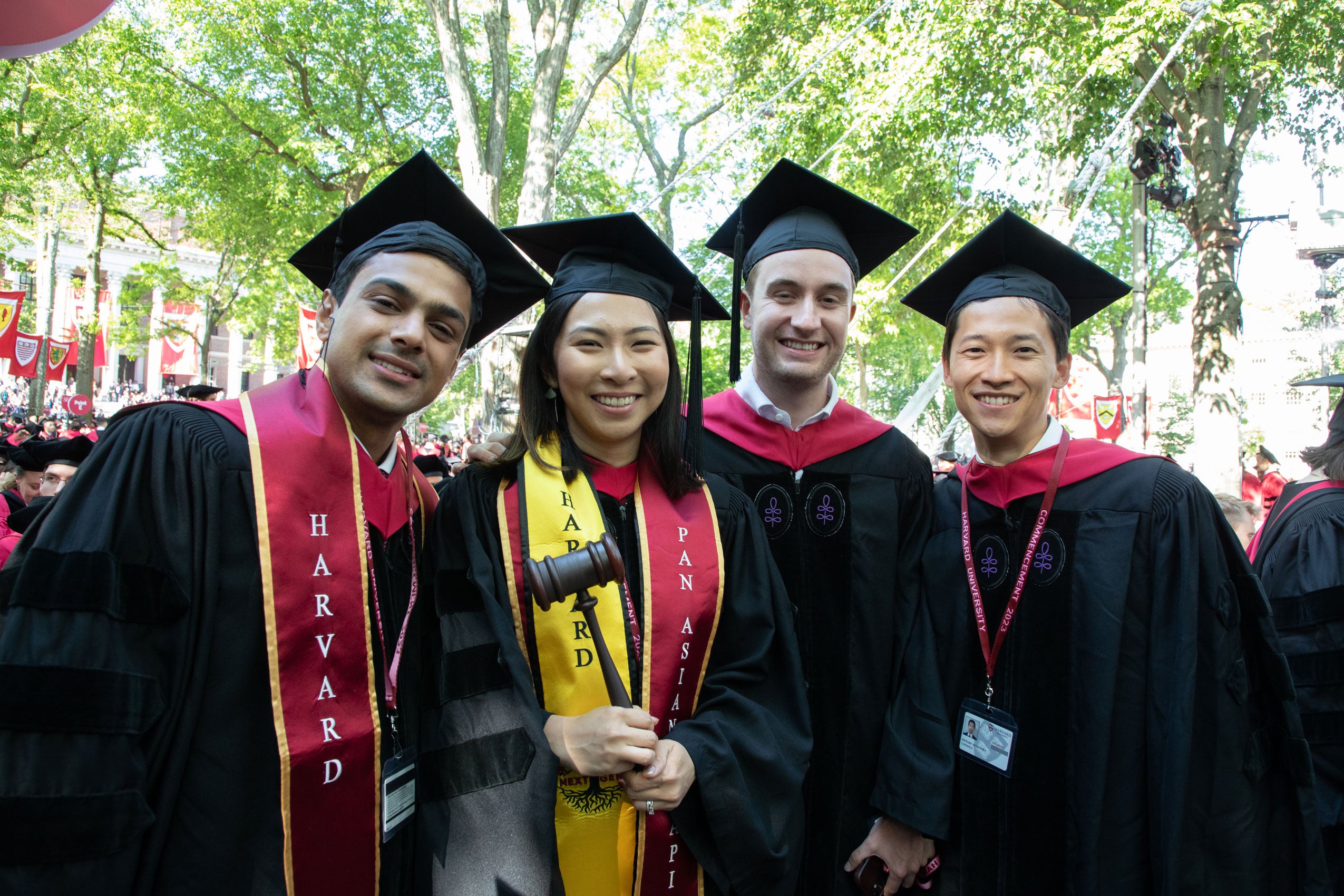 Four students pose together in regalia