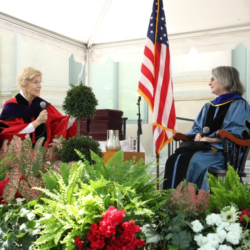 Senator Elizabeth Warren speaking on stage with Elizabeth Papp Kamali.
