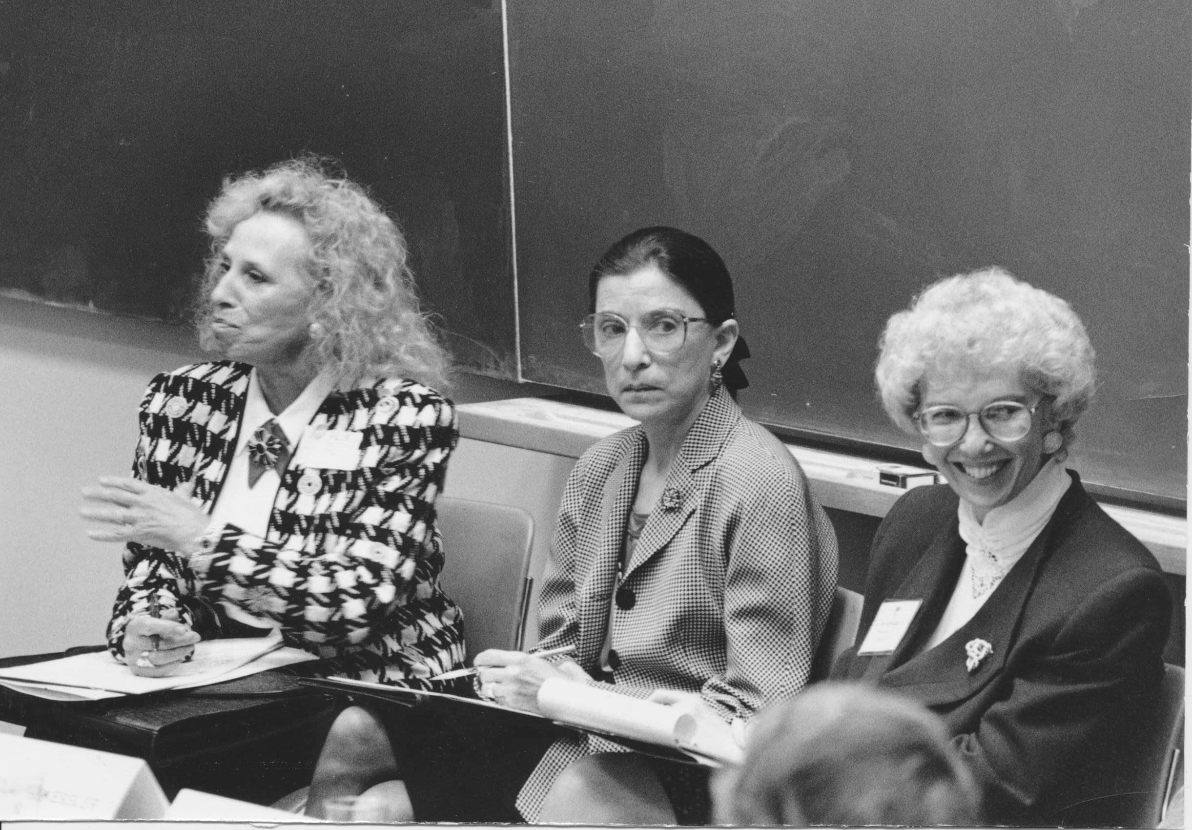 Black-and-white image of three women in a classroom