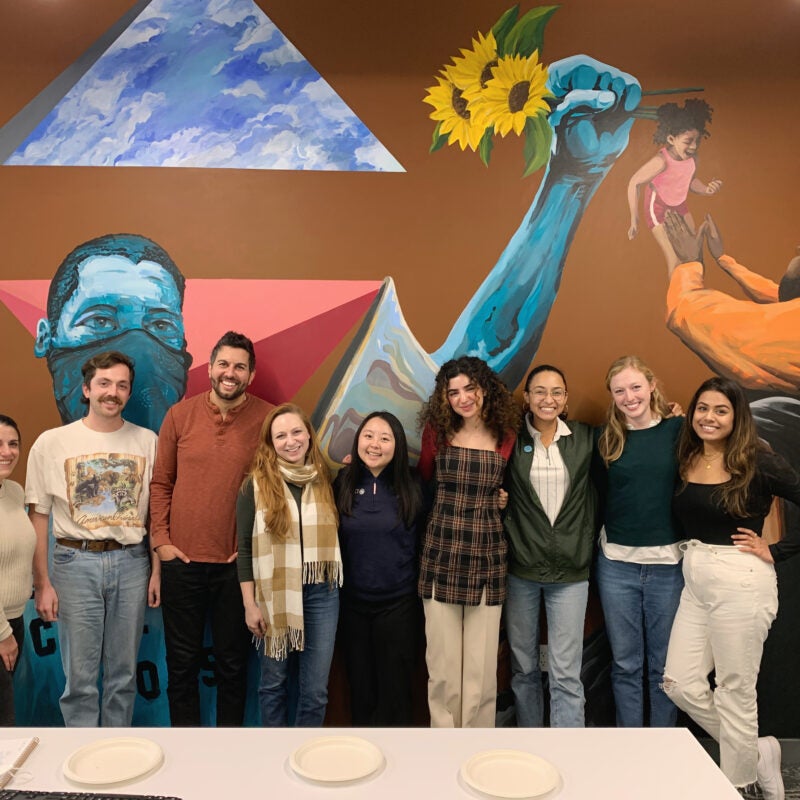 students in front of a mural at the Macarthur Justice Center