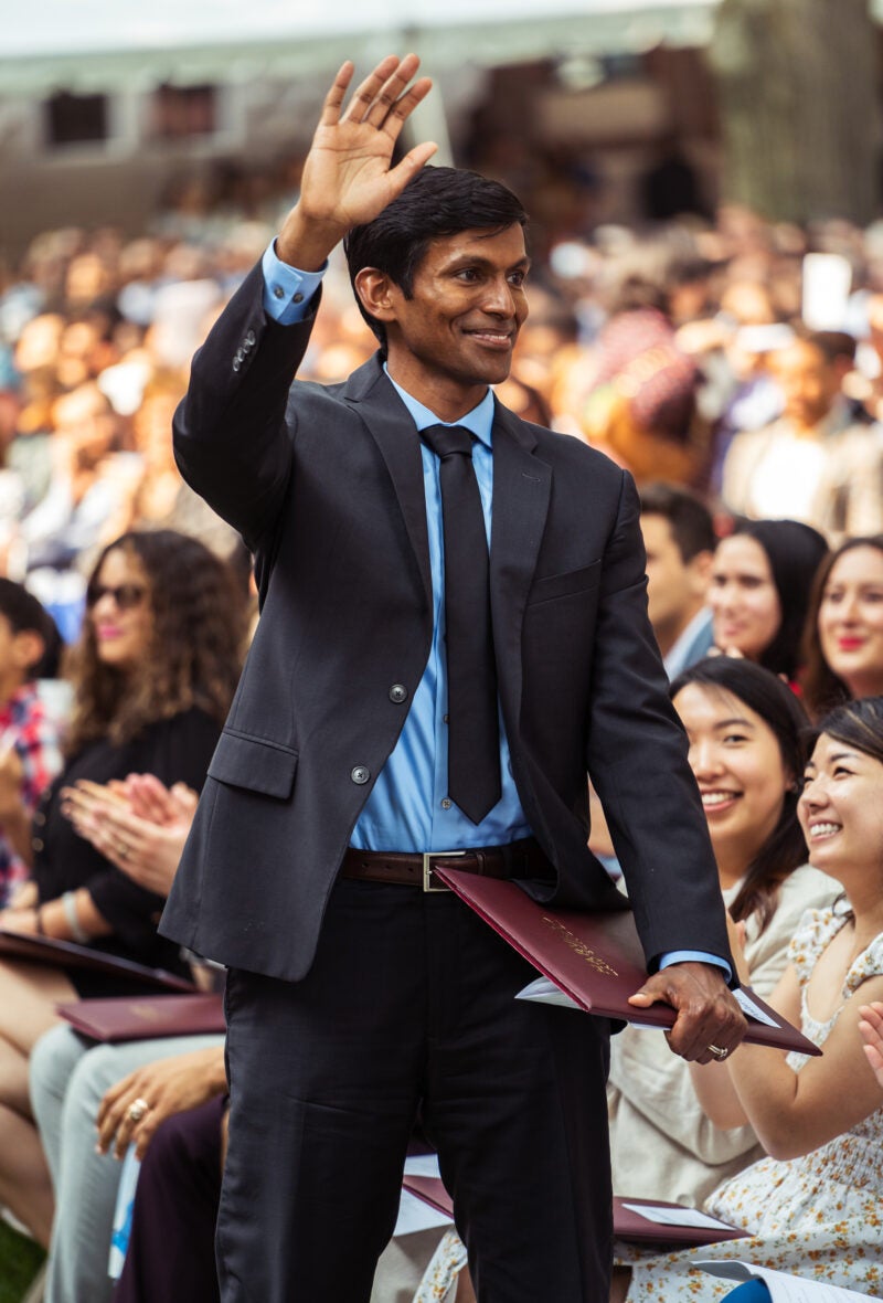 Man waves at crowd during Class Day ceremony