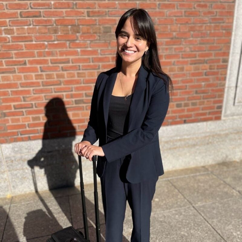 A woman stands outside court with a briefcase