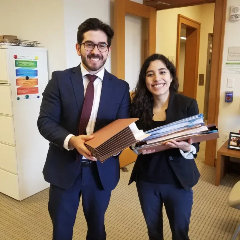 students stands with files of papers