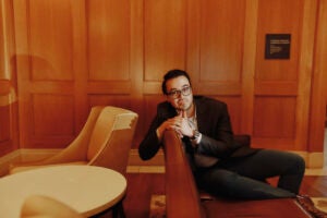 Jimenez-solis sitting on a couch in a room with wooden panels