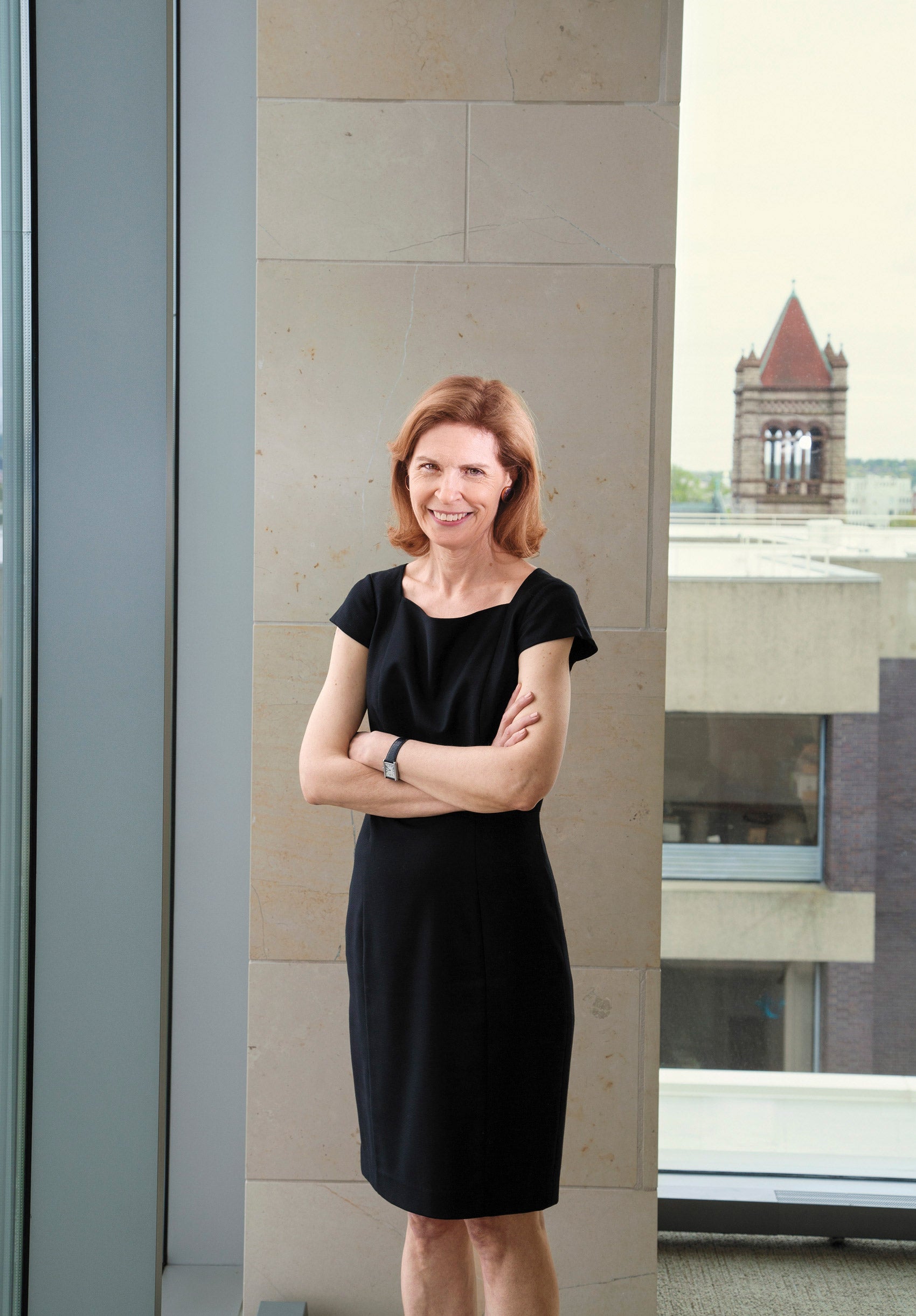 Susan Crawford standing in front of a column near a window