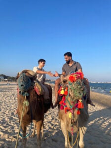 Hussein Awan riding a camel.