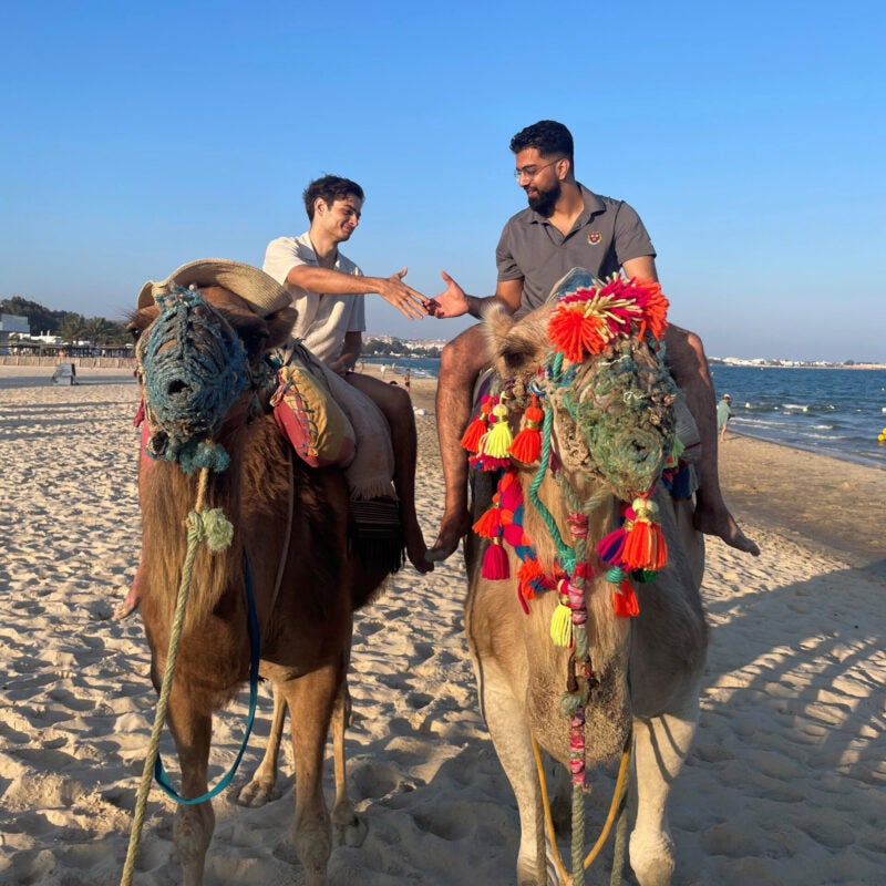 Hussein Awan riding a camel.