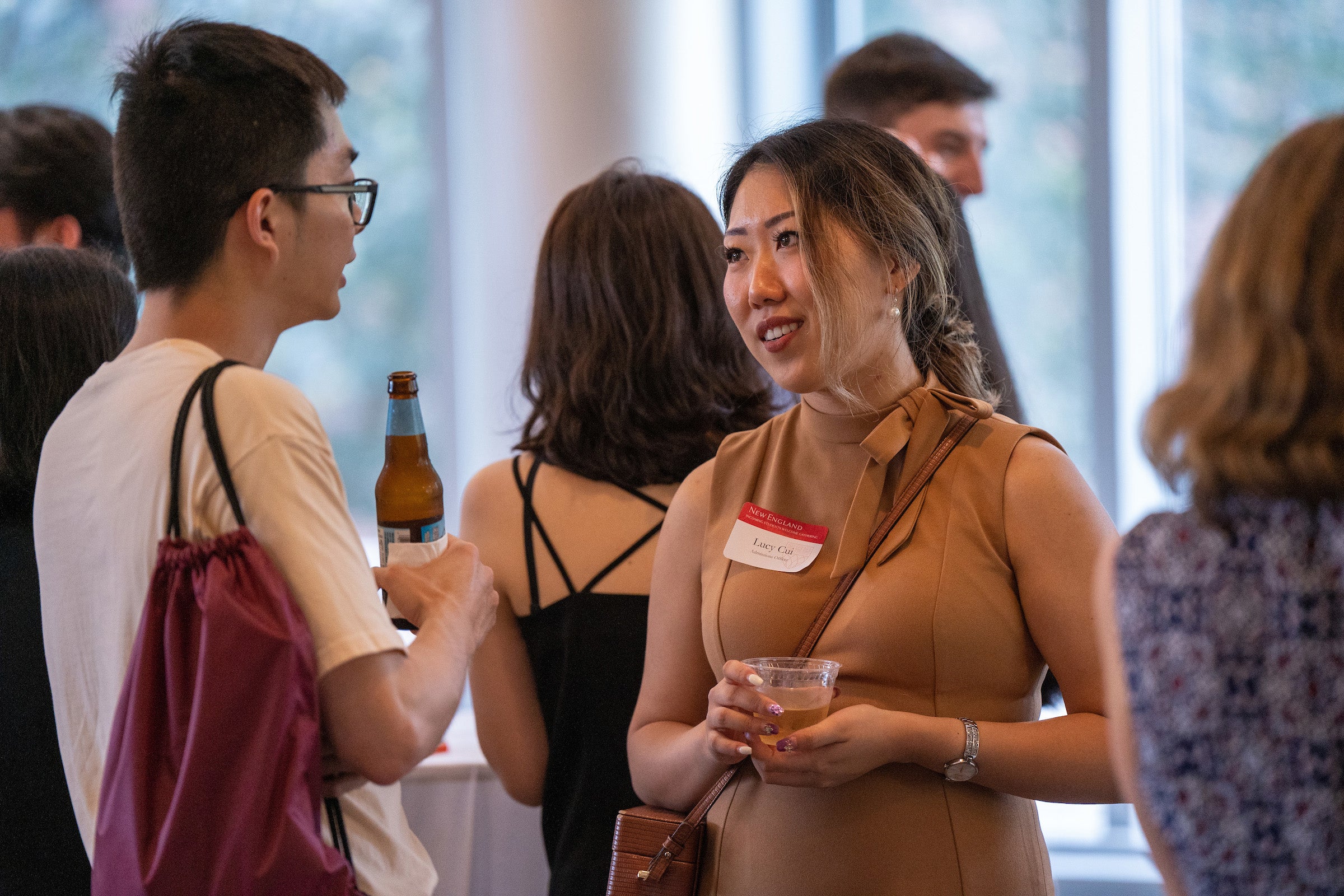 Students talking at a reception.