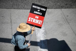 Writers Guild striker holding sign.