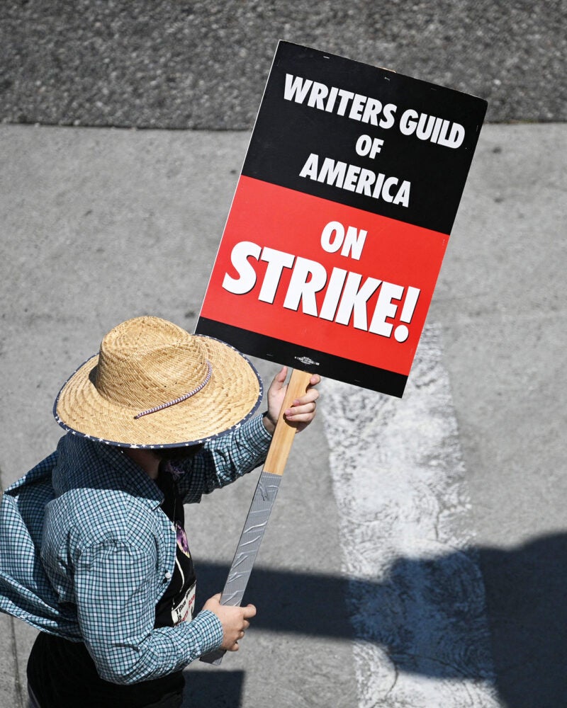 Writers Guild striker holding sign.