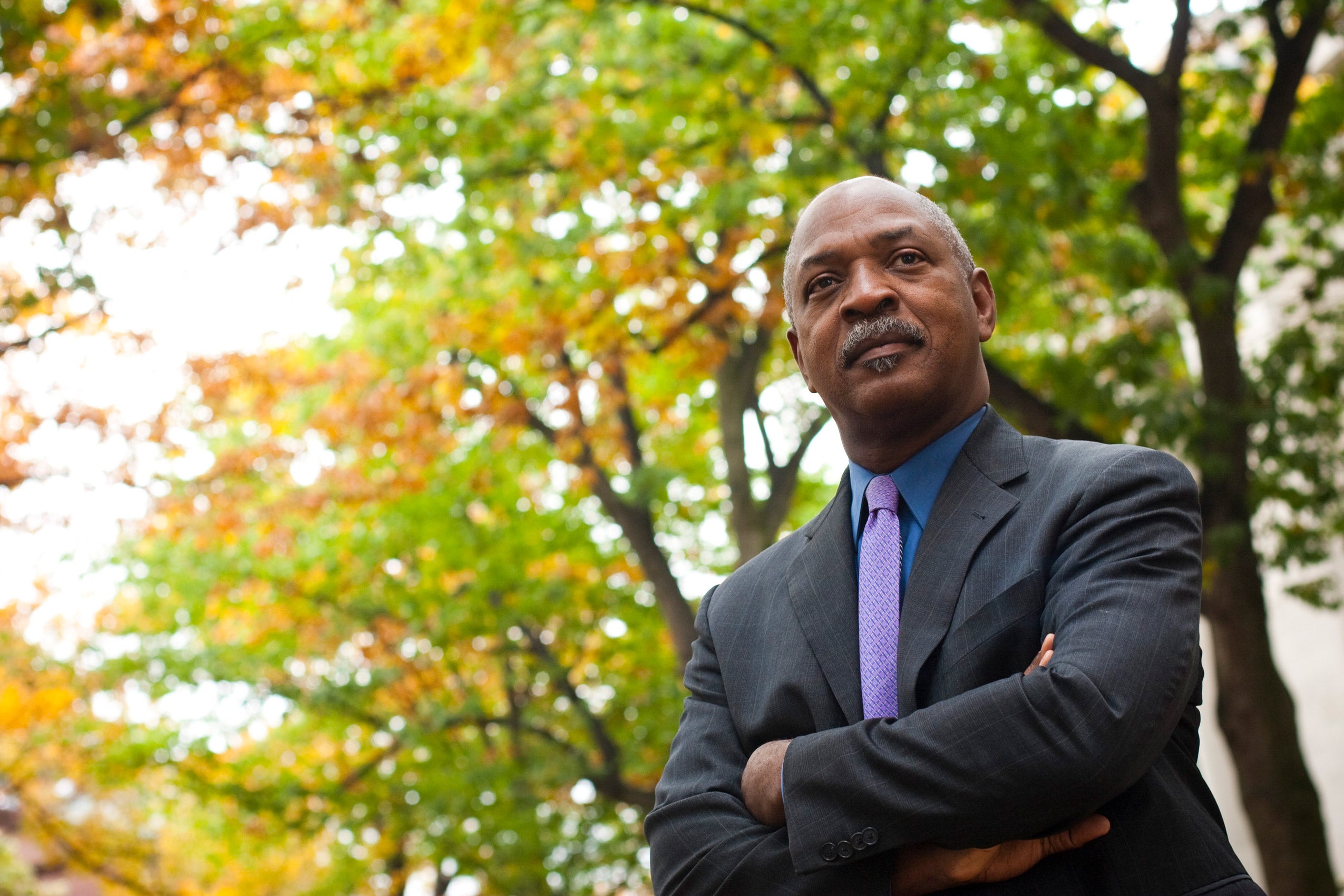 Portrait of Charles Ogletree standing outside in the fall