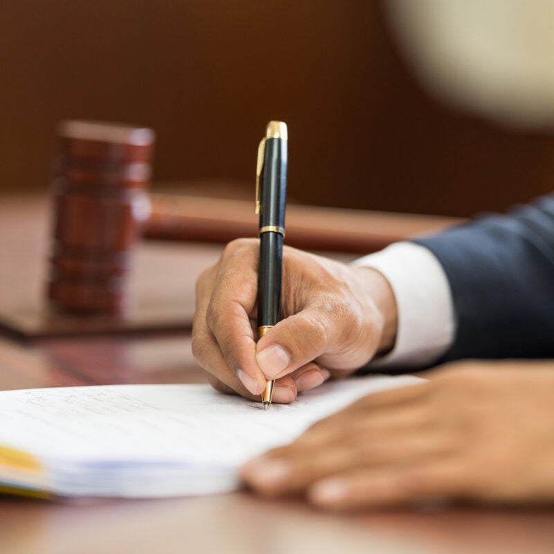 Close up of person writing.