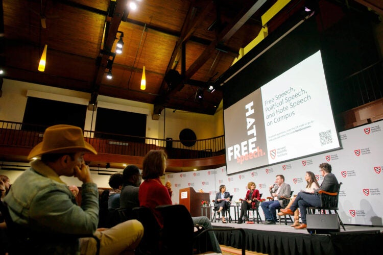Panelists on a stage.